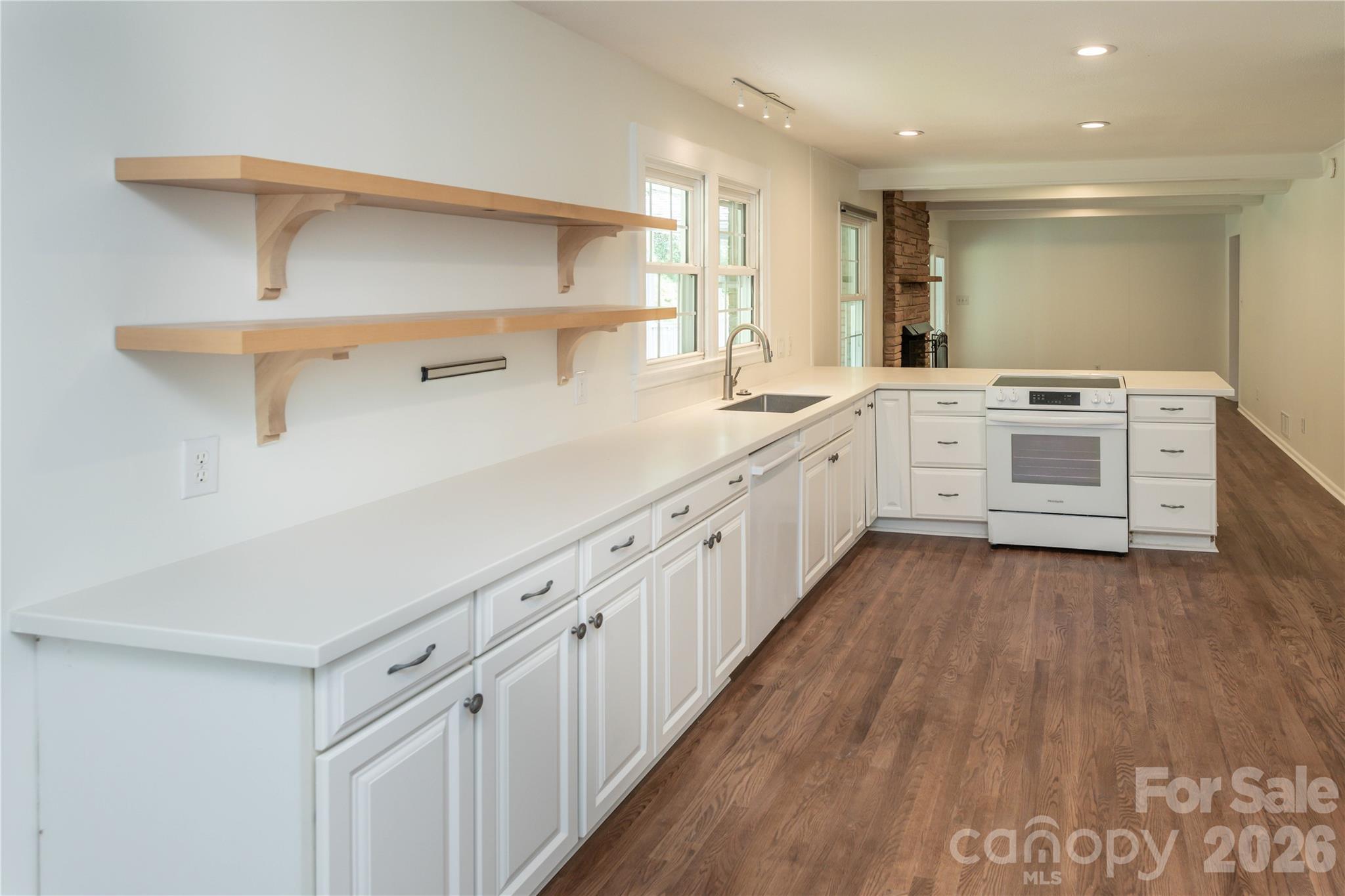 Open concept kitchen with updated cabinetry and new Bosch dishwasher and glass-top range. - 171 Suburban Avenue NE, Concord