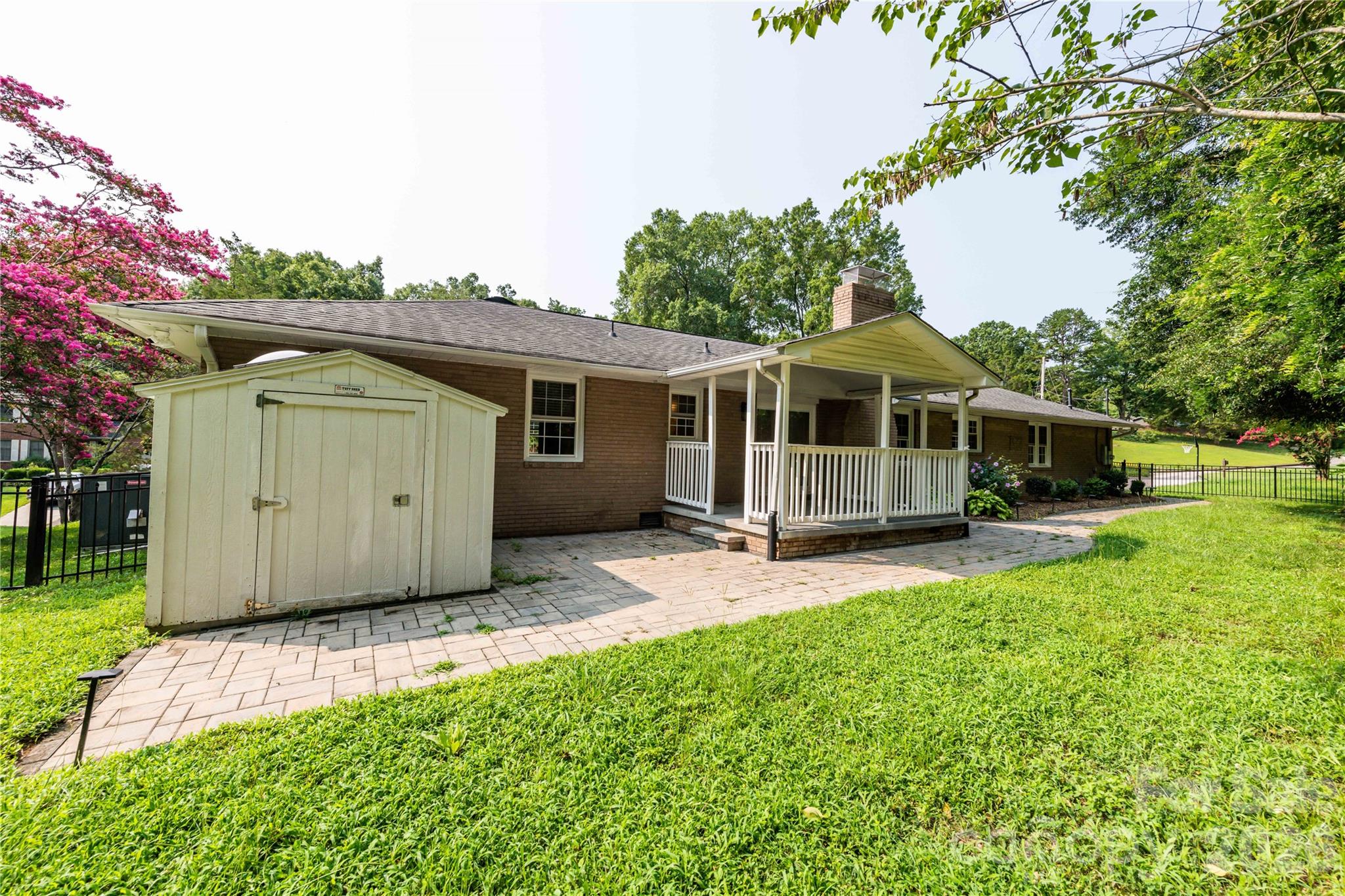 Storage shed with gated access on either side of the fenced yard. - 171 Suburban Avenue NE, Concord
