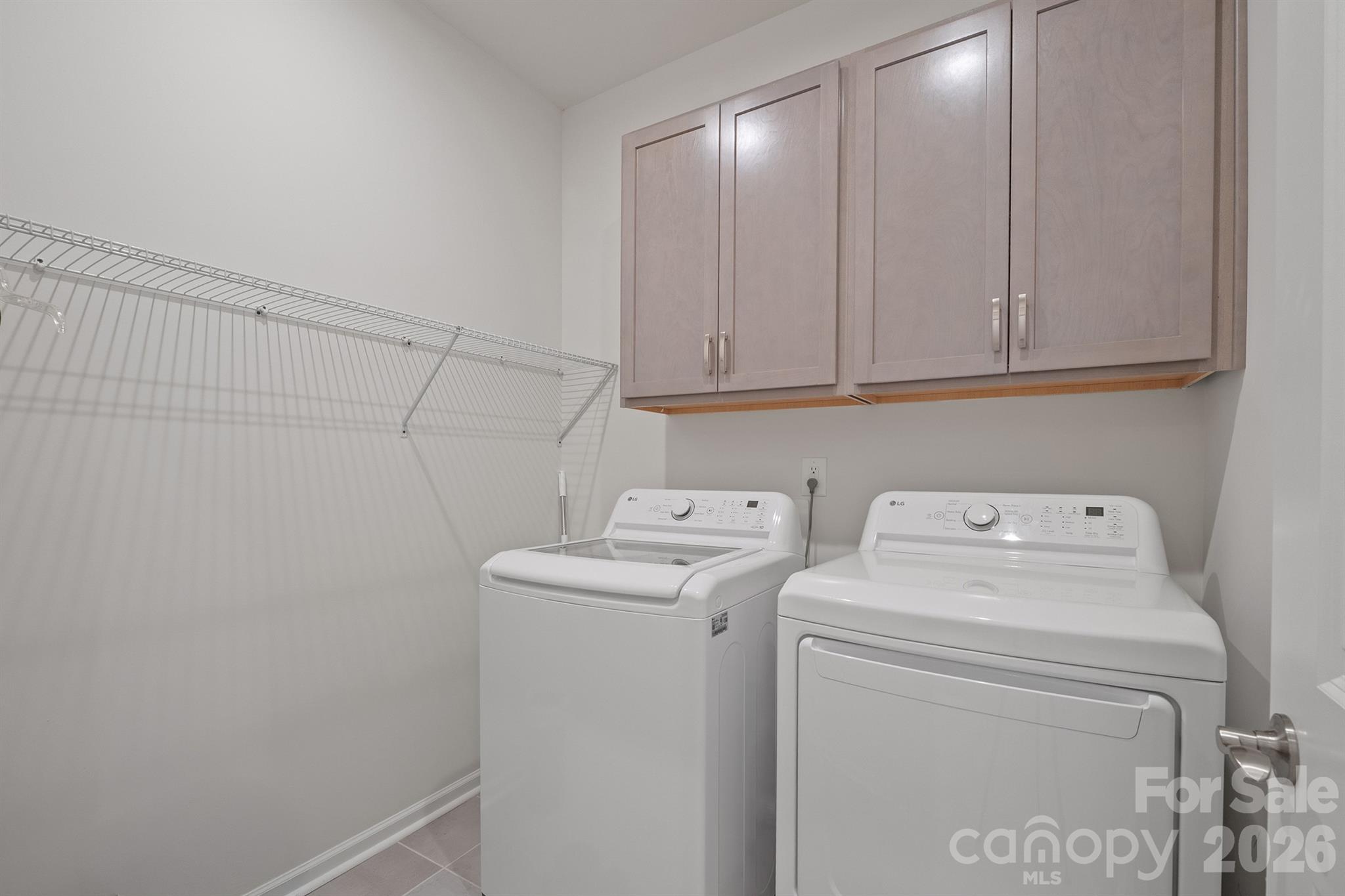 Laundry room with cabinets and tile flooring - 6161 Pierce Lane, Kannapolis