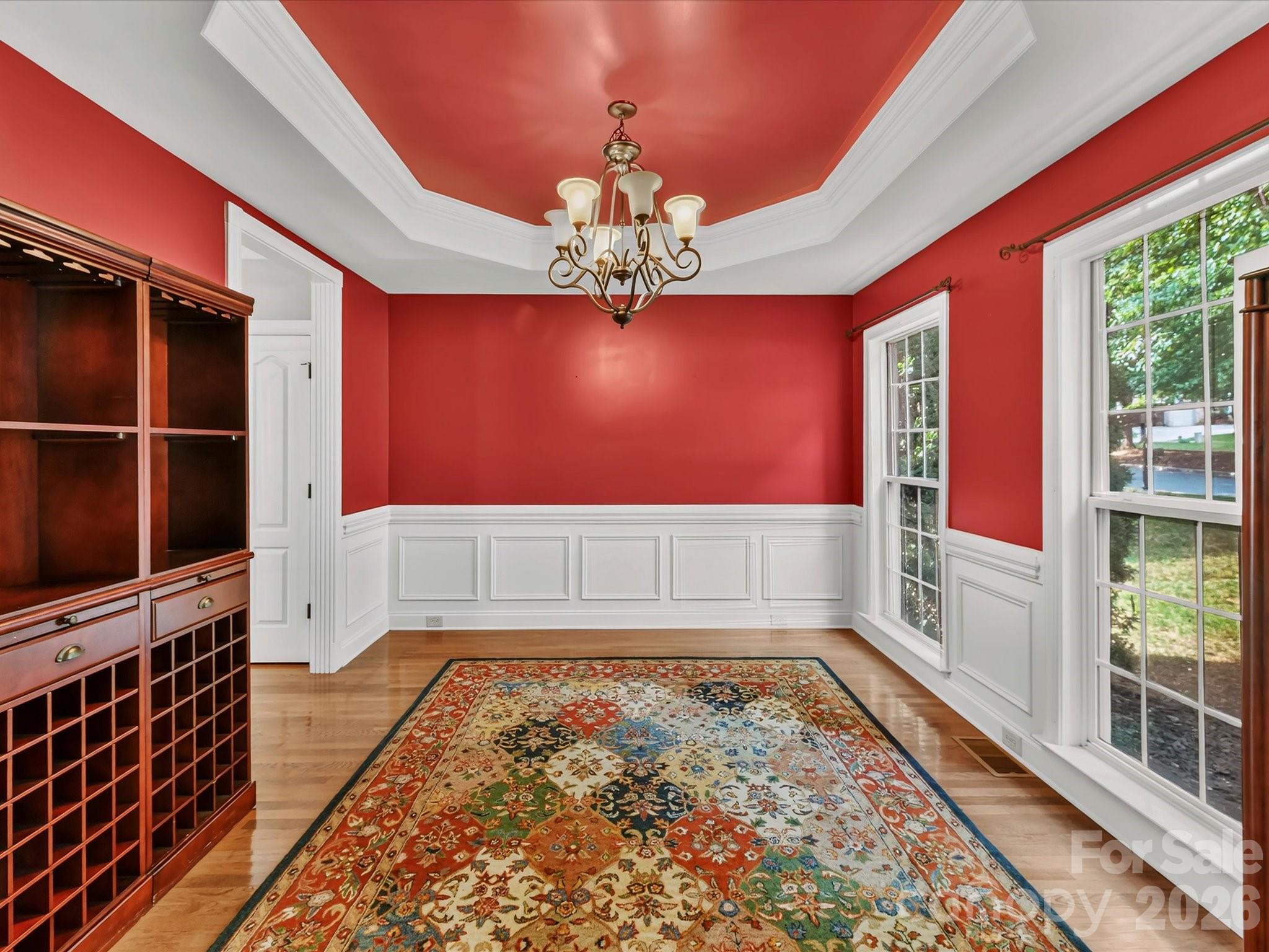 Spacious formal dining room featuring elegant trim, hardwood floors, and easy access to the kitchen for entertaining. - 11203 Warfield Avenue, Huntersville
