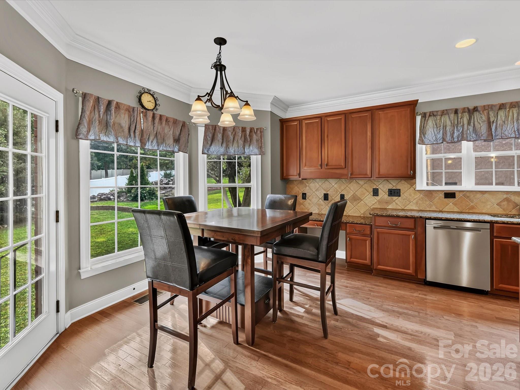 Sun-filled breakfast area surrounded by large windows and conveniently located just off the kitchen. - 11203 Warfield Avenue, Huntersville