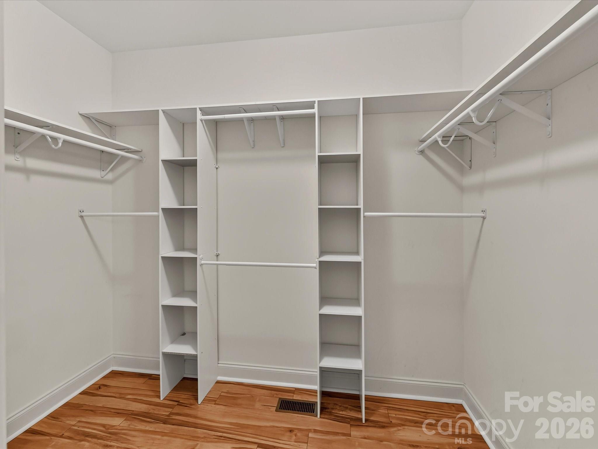 Expansive walk-in primary closet offers built-in shelving and abundant hanging and storage space. - 11203 Warfield Avenue, Huntersville