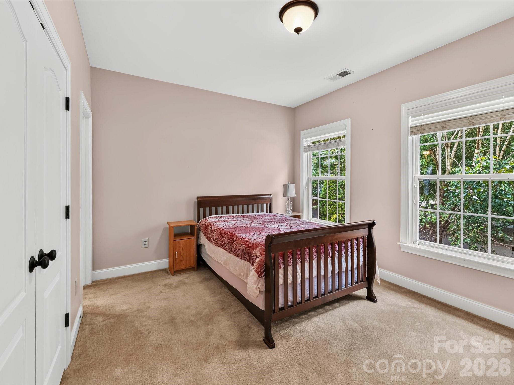 Bright secondary bedroom offers generous space, ample natural light, and convenient access to an adjoining bathroom. - 11203 Warfield Avenue, Huntersville