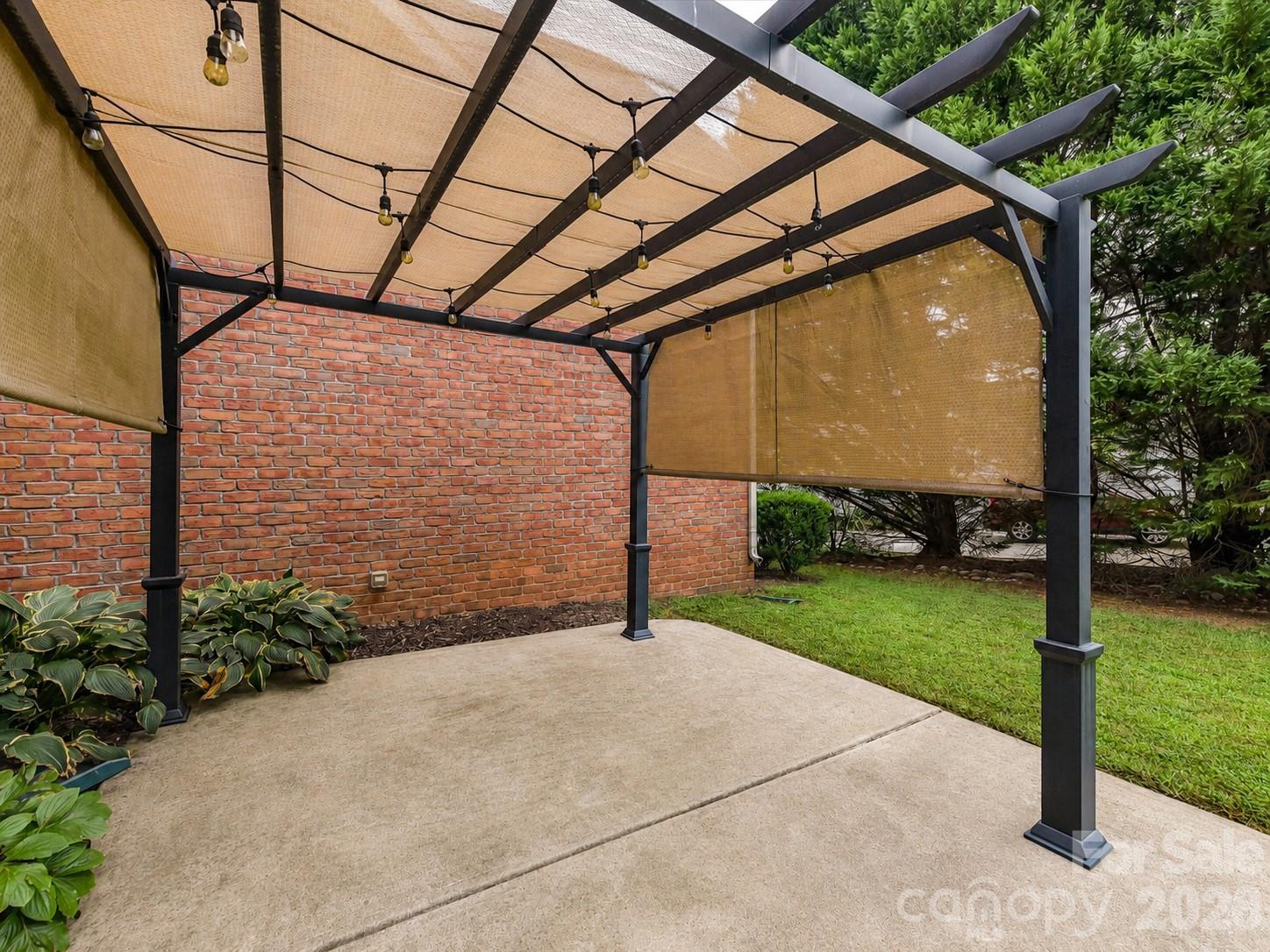 Covered patio and pergola-style outdoor living area create a great space for relaxing, dining, and entertaining outdoors. - 11203 Warfield Avenue, Huntersville
