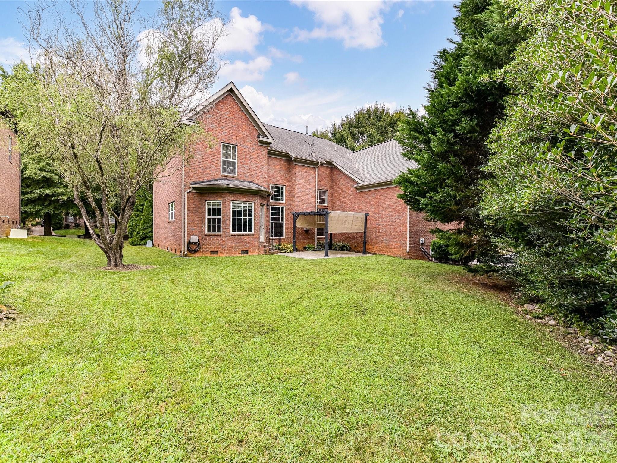 Spacious backyard with mature landscaping offers plenty of room for outdoor recreation, entertaining, or gardening. - 11203 Warfield Avenue, Huntersville