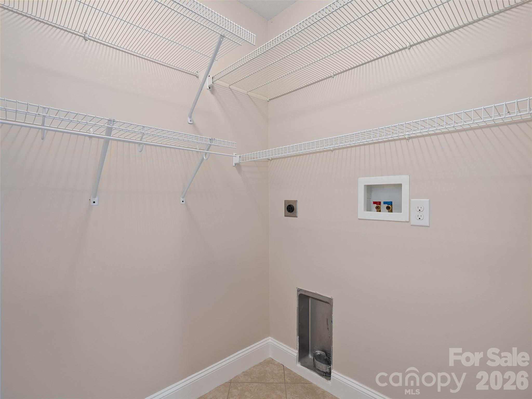 Laundry Room Conveniently Located in Oversized Primary Closet - 11 Tahchee Trail, Fletcher