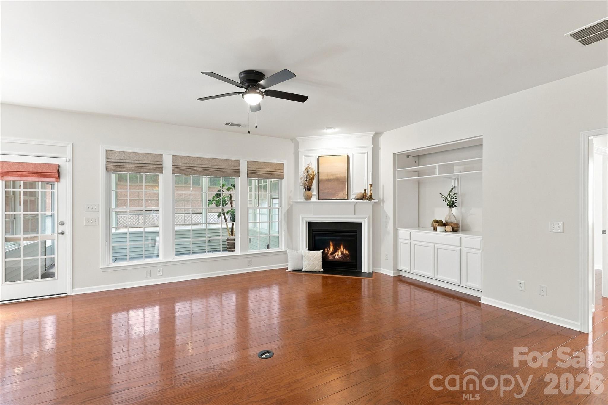 Custom built-in cabinetry provides stylish display shelving and convenient concealed storage for a polished, functional finishing touch - 10345 Scotland Avenue, Indian Land