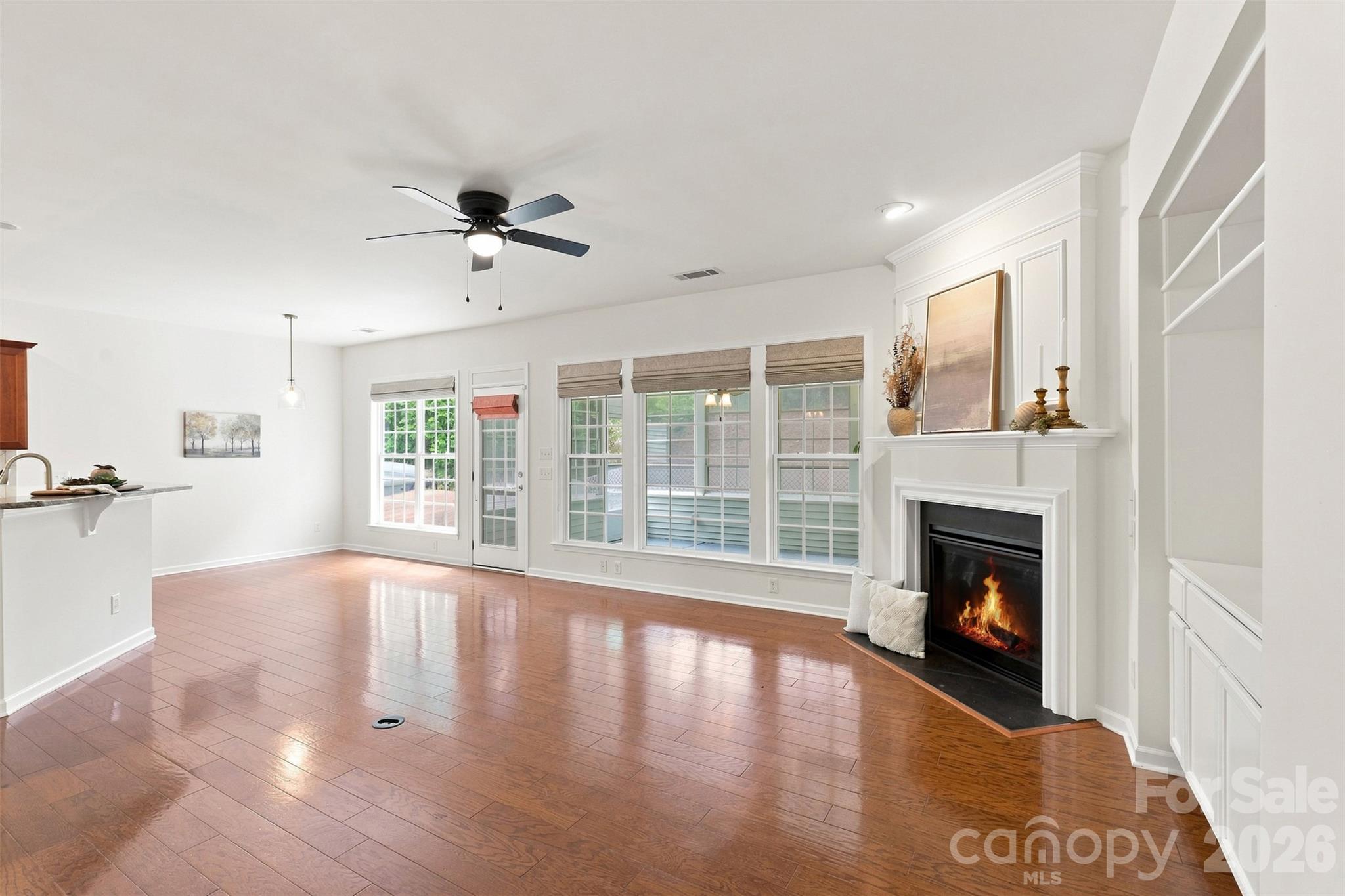 spacious layout, wall of windows, open staircase, and seamless flow into the adjoining kitchen and dining areas - 10345 Scotland Avenue, Indian Land