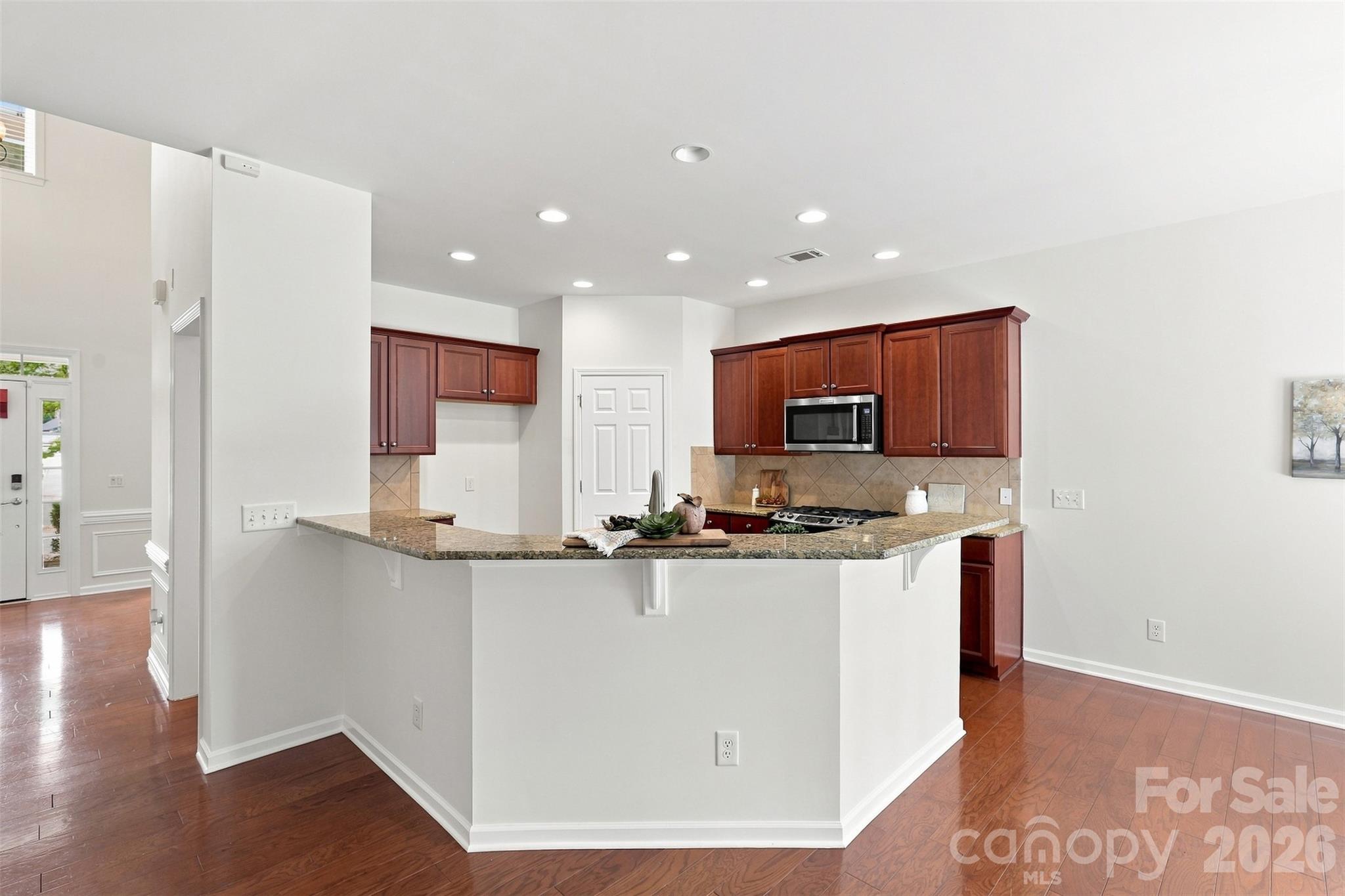 Wraparound breakfast bar offers ample seating for casual meals, morning coffee, homework, or conversation with the cook - 10345 Scotland Avenue, Indian Land