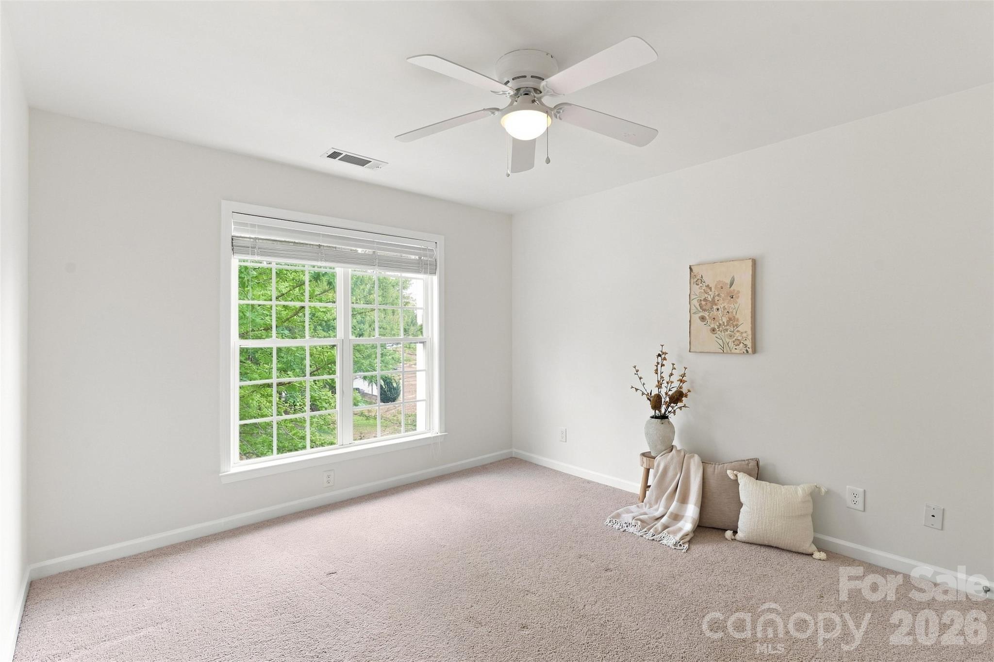 Bright secondary bedroom enjoys peaceful views of the tree-lined backyard and direct access to the shared full bath - 10345 Scotland Avenue, Indian Land