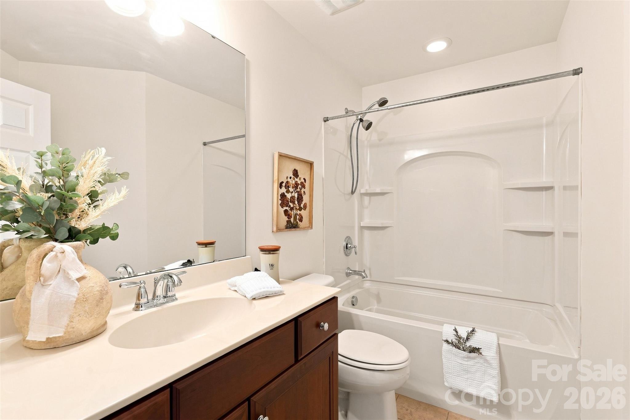 Shared full bath serves both secondary bedrooms and features a spacious vanity plus a tub-and-shower combination - 10345 Scotland Avenue, Indian Land