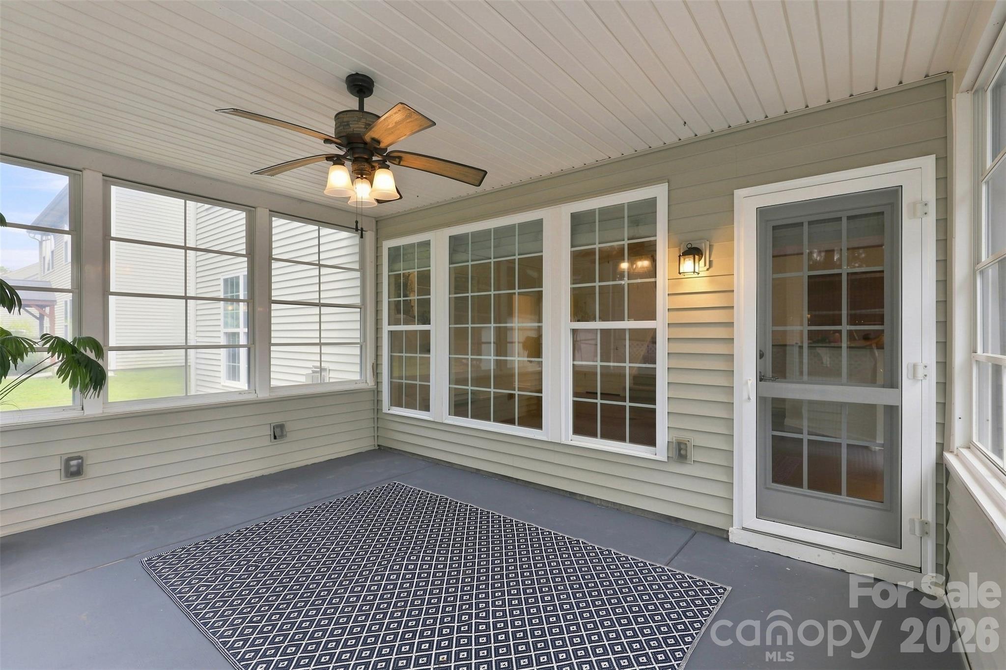 Spacious four-seasons room extends the main living area with multi-panel windows that invite fresh air and provide a comfortable setting for relaxing or entertaining - 10345 Scotland Avenue, Indian Land