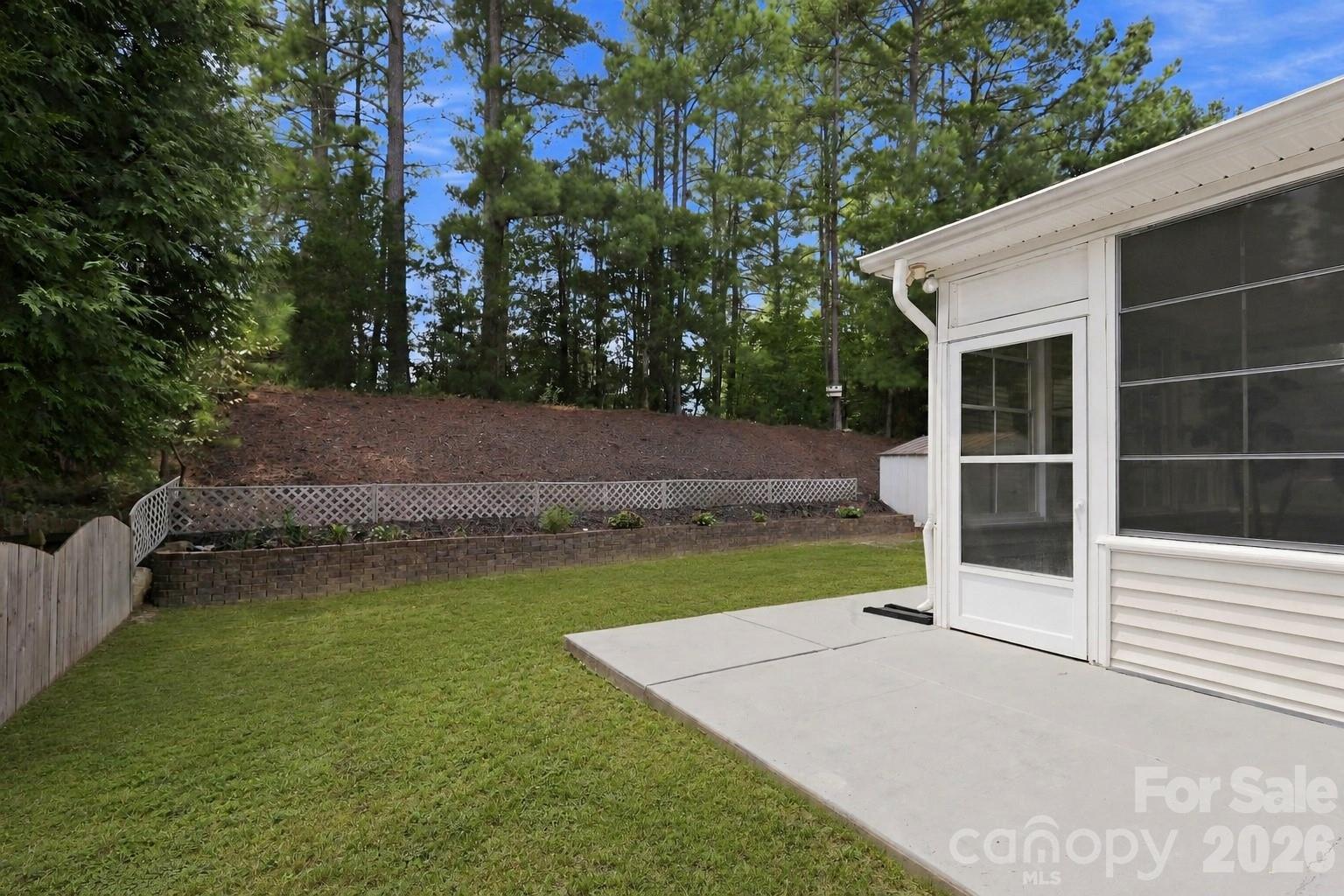 A convenient door from the four-seasons room leads directly to the concrete patio and backyard, creating an easy transition for grilling, outdoor dining, and everyday enjoyment - 10345 Scotland Avenue, Indian Land