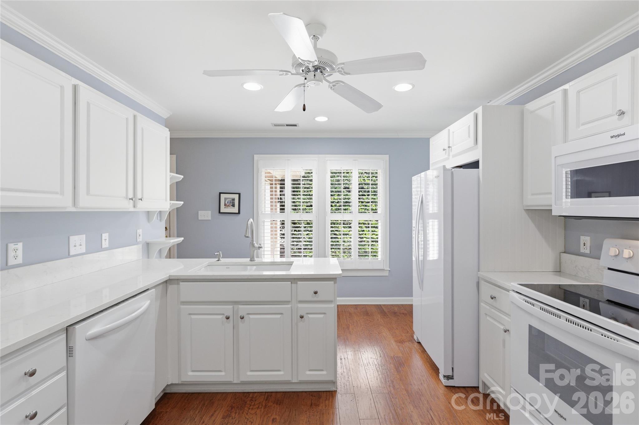 Crisp white cabinets and quartz counters. Gas line easy access to convert stove. - 18 Creekside Way, Asheville