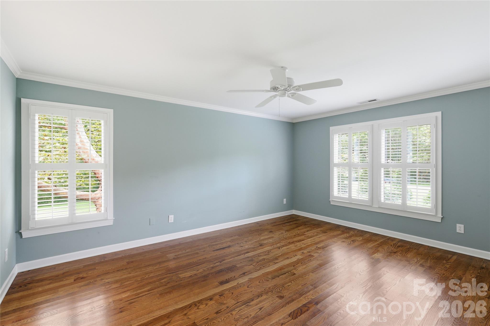 Spacious primary: 16.5'x 13' with gleaning hardwoods and beautiful trees outside. - 18 Creekside Way, Asheville