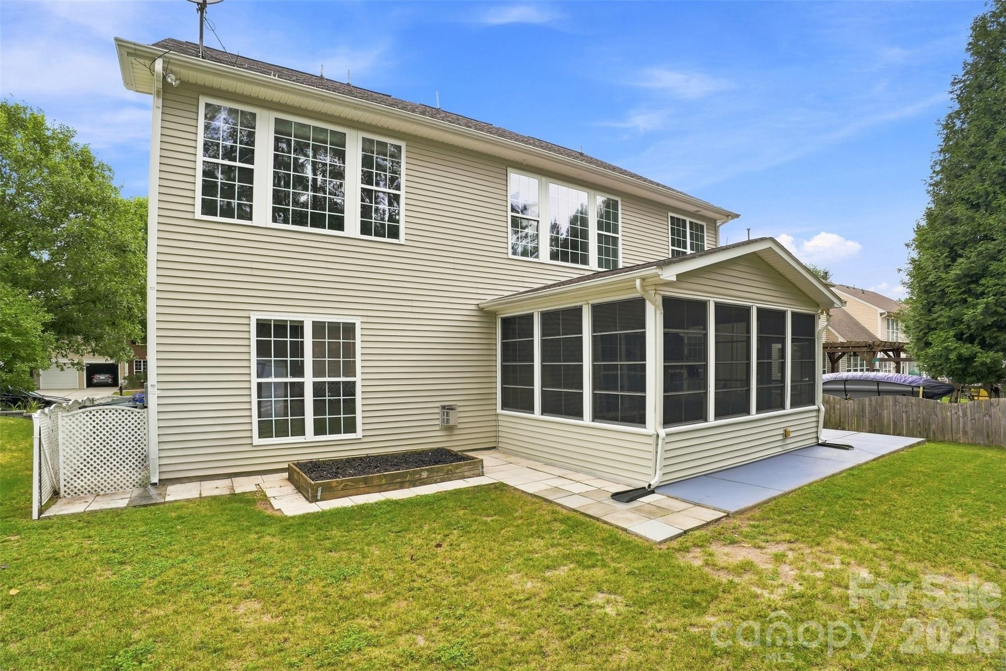 Low-maintenance exterior siding helps simplify upkeep, while the raised garden box is ready for seasonal vegetables, herbs, or flowers - 10345 Scotland Avenue, Indian Land
