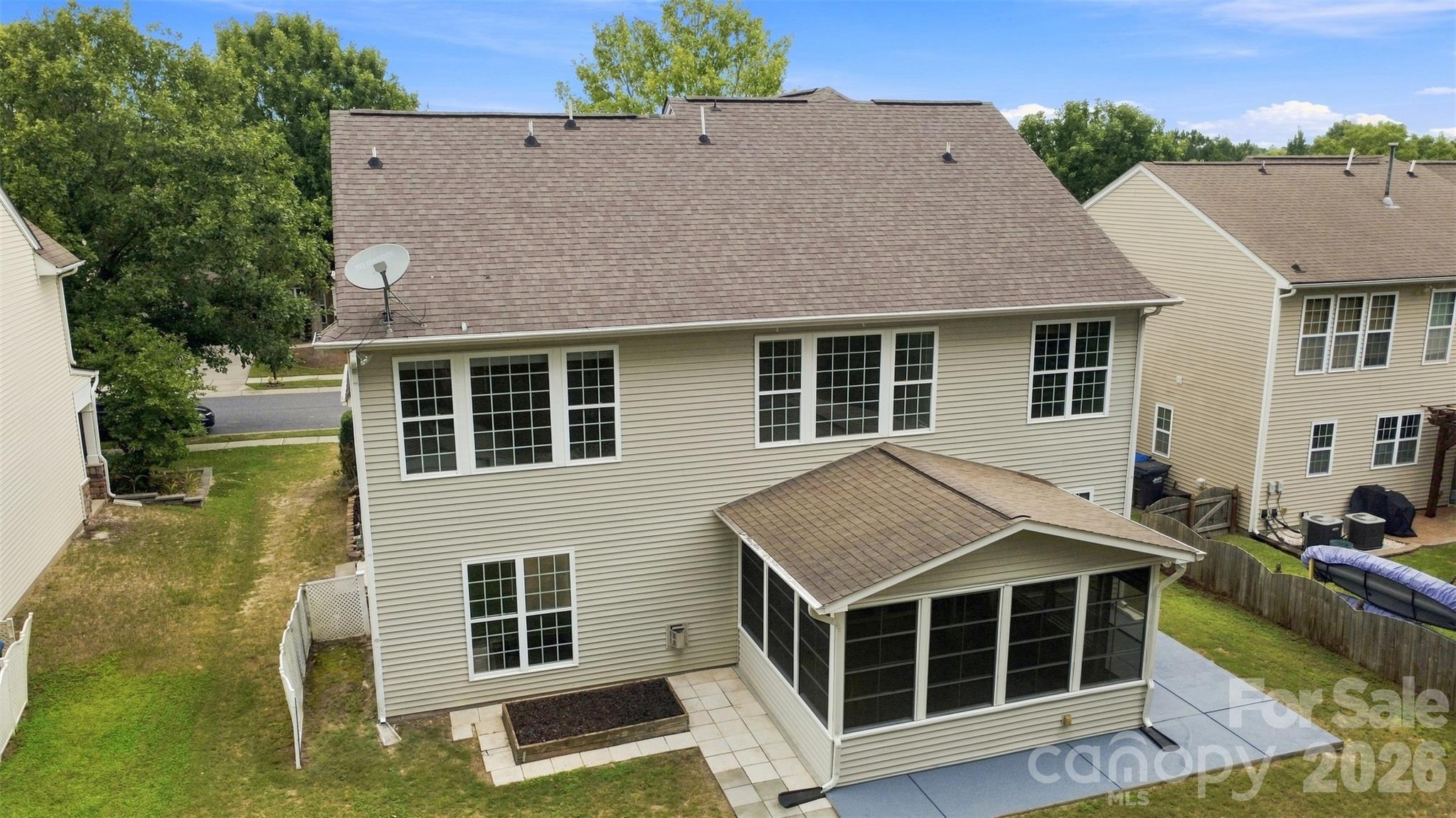 Aerial view highlights the home’s substantial size and attractive rear elevation within Belair at Carolina Lakes. A separate storage shed provides additional space for lawn equipment, tools, and seasonal items - 10345 Scotland Avenue, Indian Land
