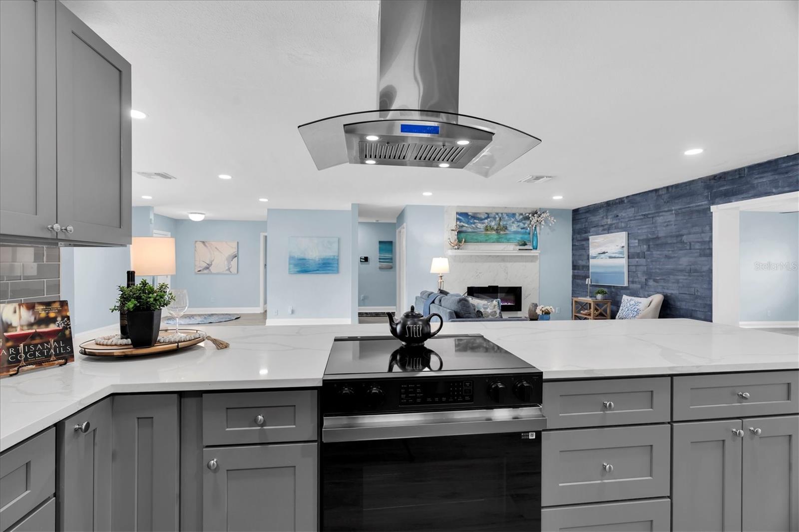 New stainless-steel appliances include a vented range hood and French-door refrigerator with an illuminated glass display panel. - 7891 4TH AVE S, ST PETERSBURG
