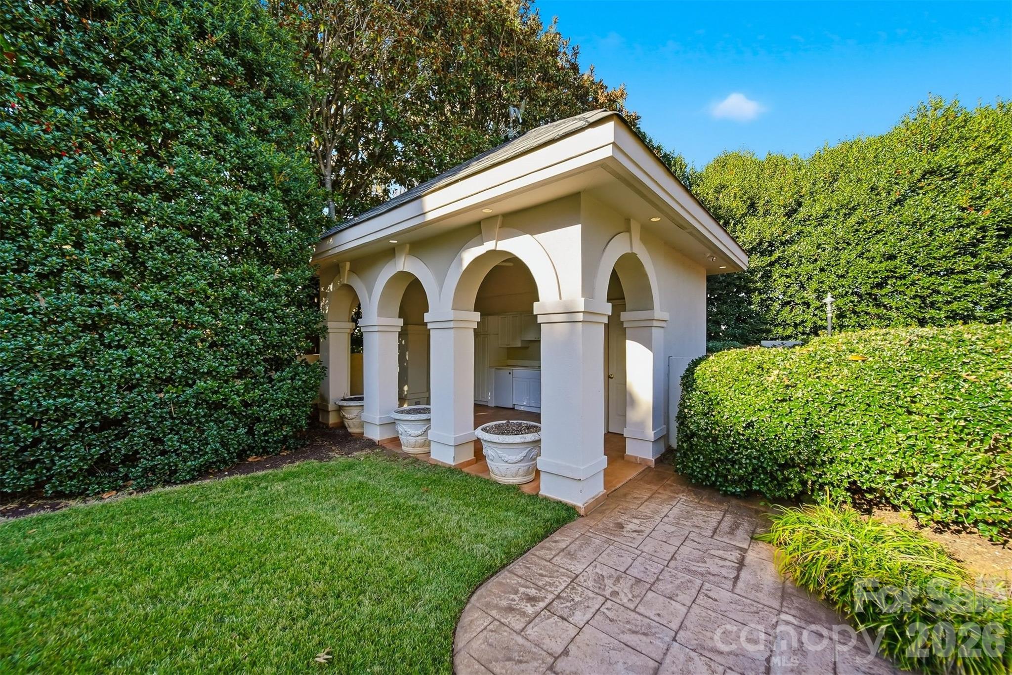 Covered rear patio offering seamless indoor-outdoor living and half bath - 3619 Links Drive NE, Conover