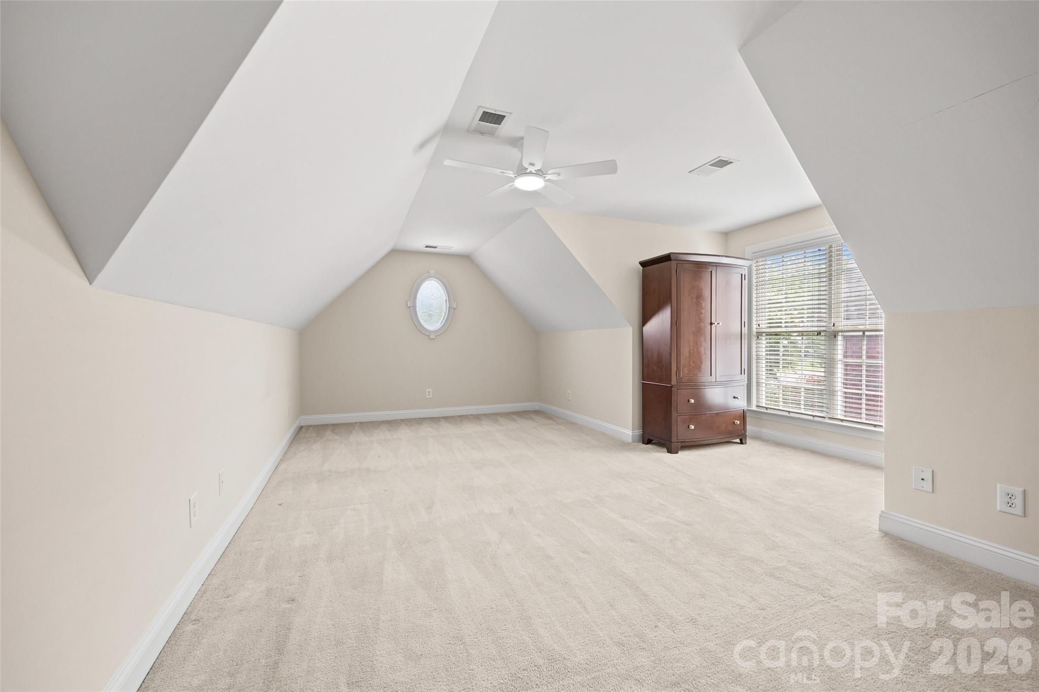 Bonus Room was used as the 4th Bedroom. Windows letting in lots of light and the armoire will remain for clothes storage. Attic with storage off of this room. Very Private. - 771 Cherry Hills Place, Rock Hill