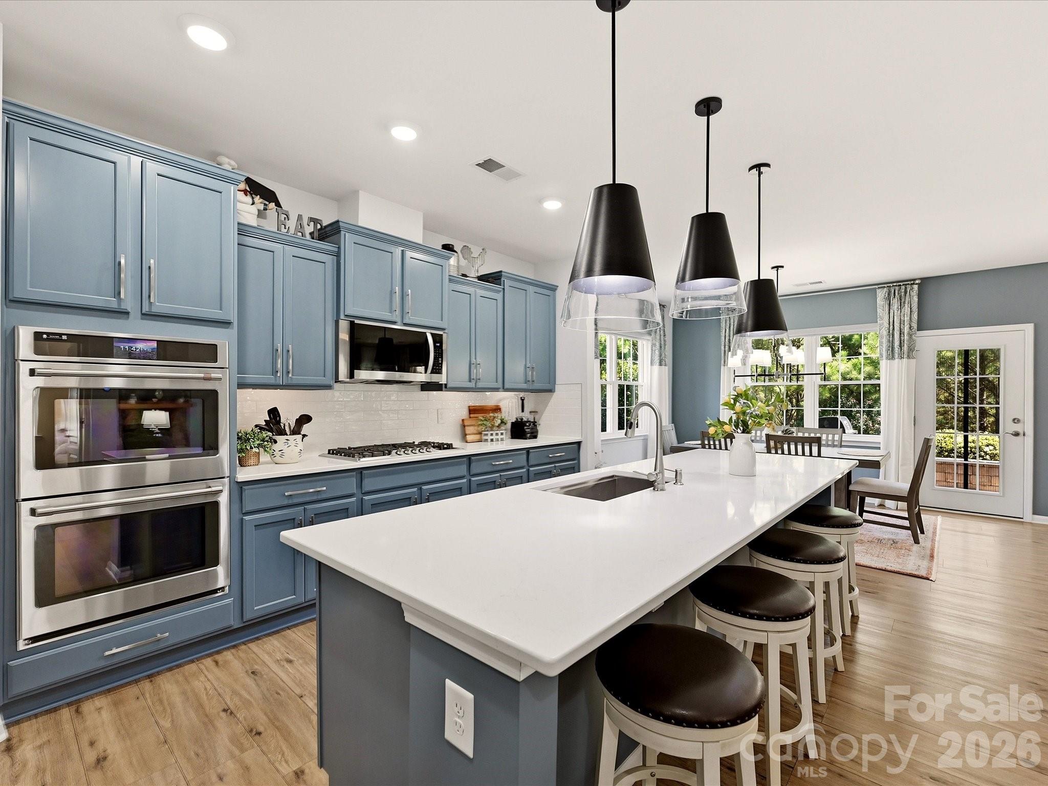 Gourmet Kitchen w/Double Convection Wall Ovens, Vented to Exterior Microwave, Painted Cabinets with Under Counter Lighting and Upgraded Pendant Lighting - 5060 Big Bend Drive, Lancaster