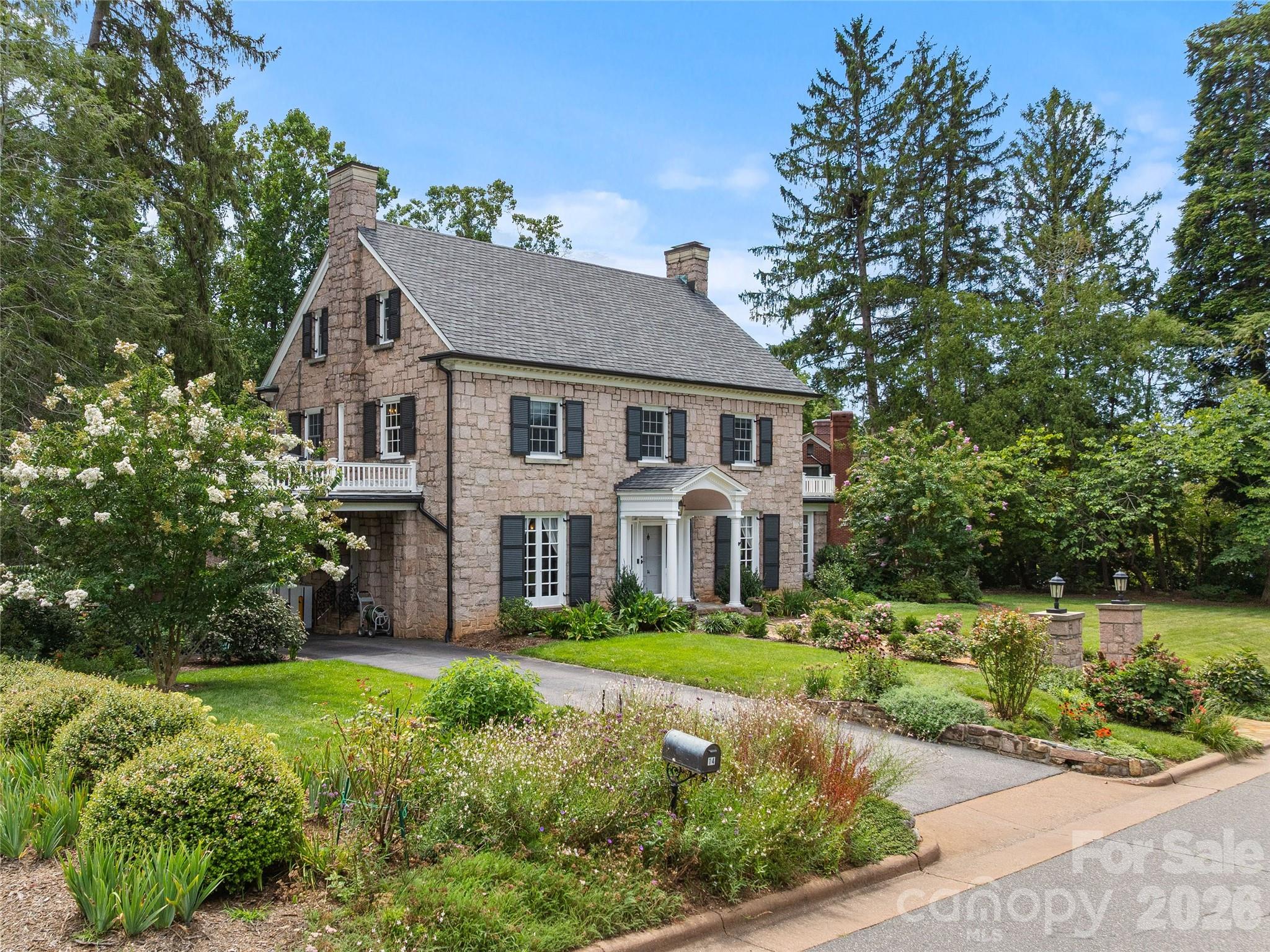 Beautifully landscaped grounds frame the historic stone home. - 14 Griffing Boulevard, Asheville