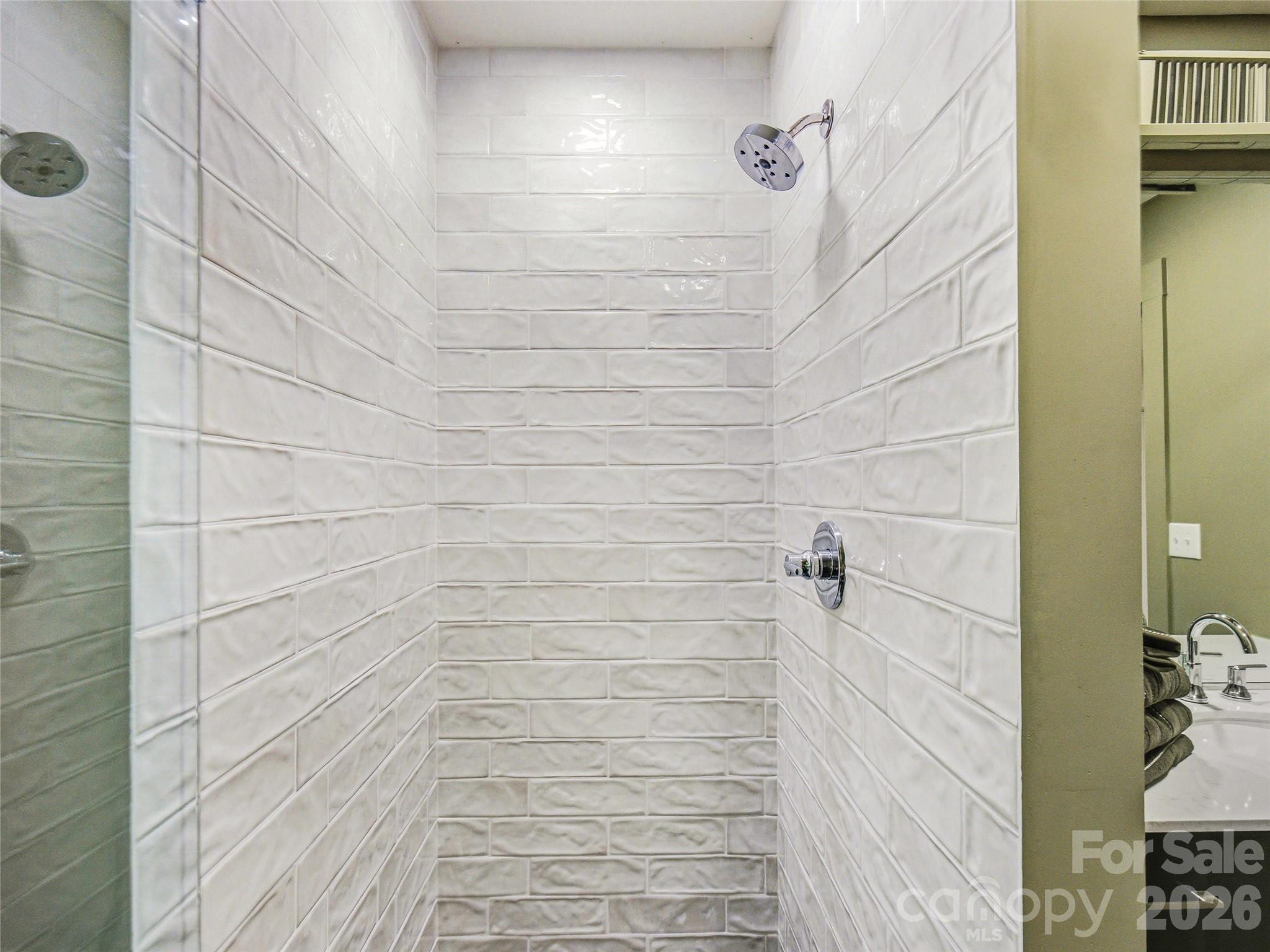 Beautifully updated en-suite bathroom featuring a tiled shower with seamless glass doors and stylish modern finishes. - 81 Summer Trees Lane, Burnsville