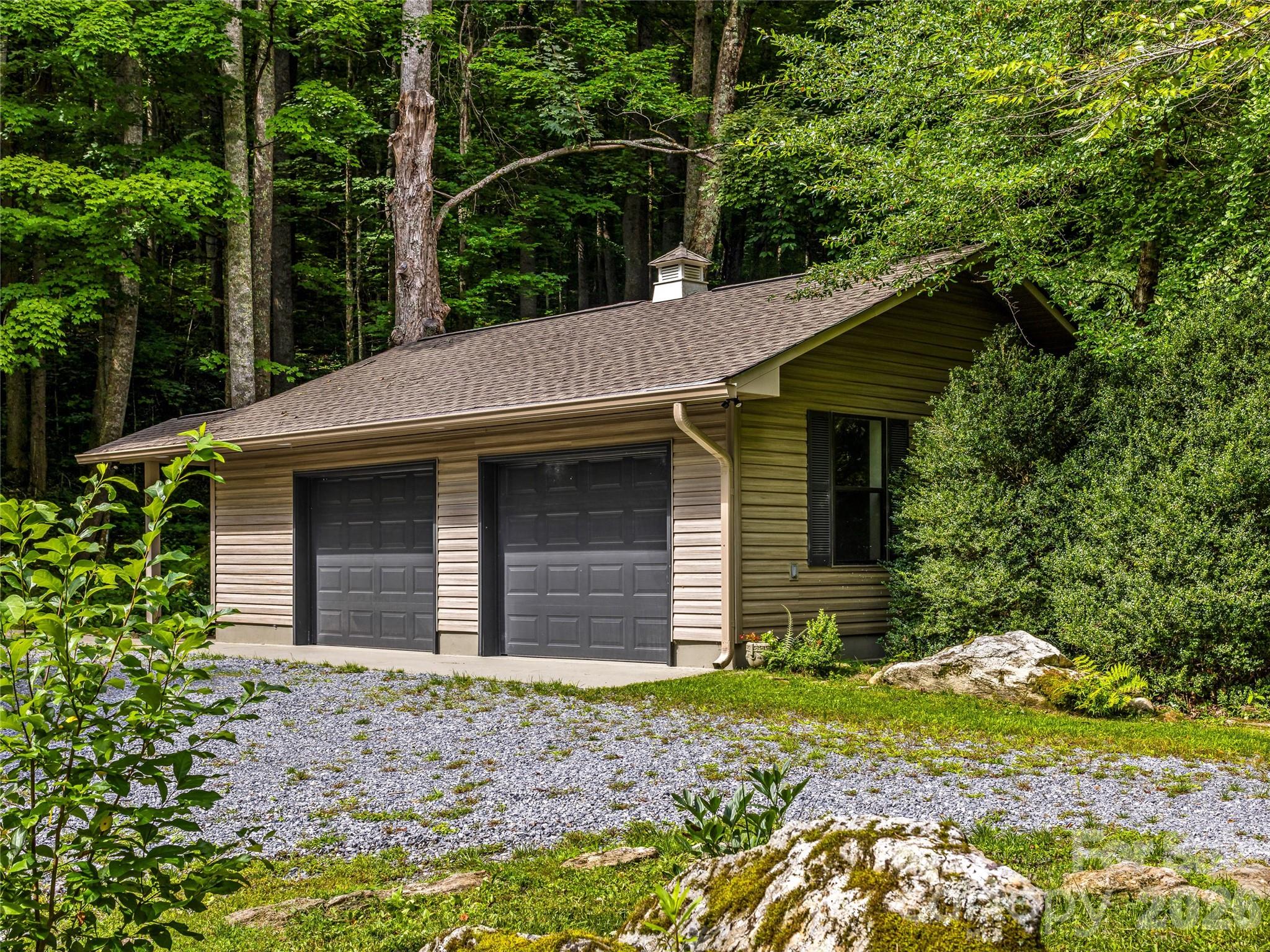 Oversized detached two-car garage featuring fresh paint, newly finished flooring, and a spacious attic for additional storage. - 81 Summer Trees Lane, Burnsville