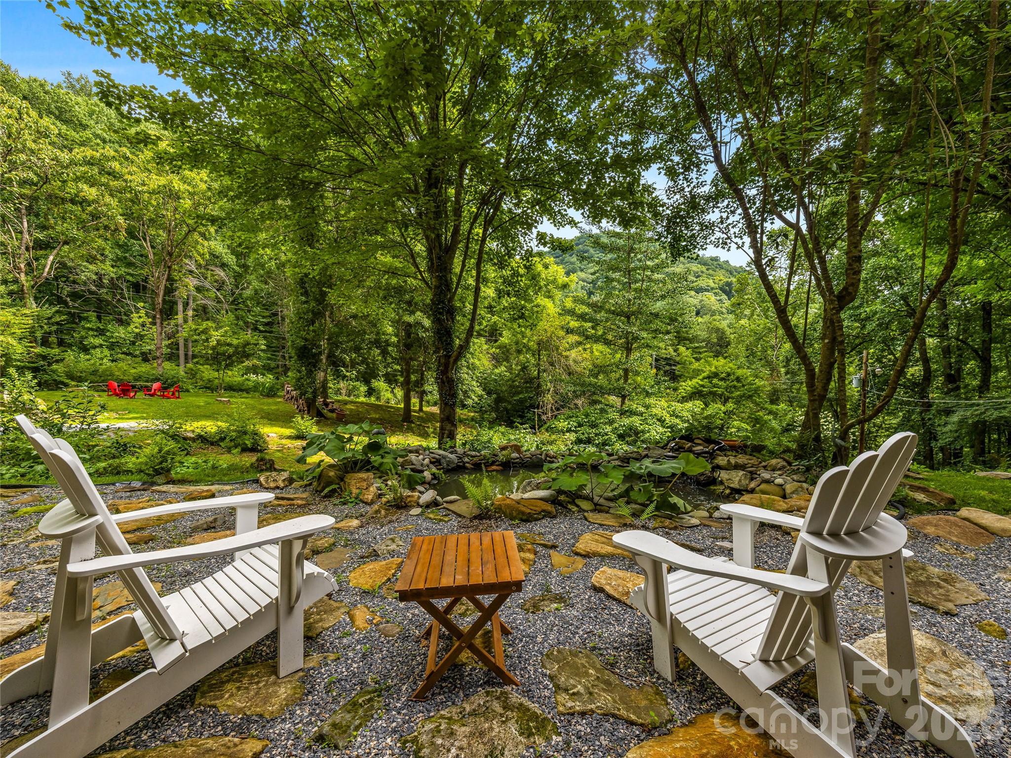 Relax beside the tranquil pond and enjoy the gently sloping landscape with picturesque views of a neighboring antique barn. - 81 Summer Trees Lane, Burnsville