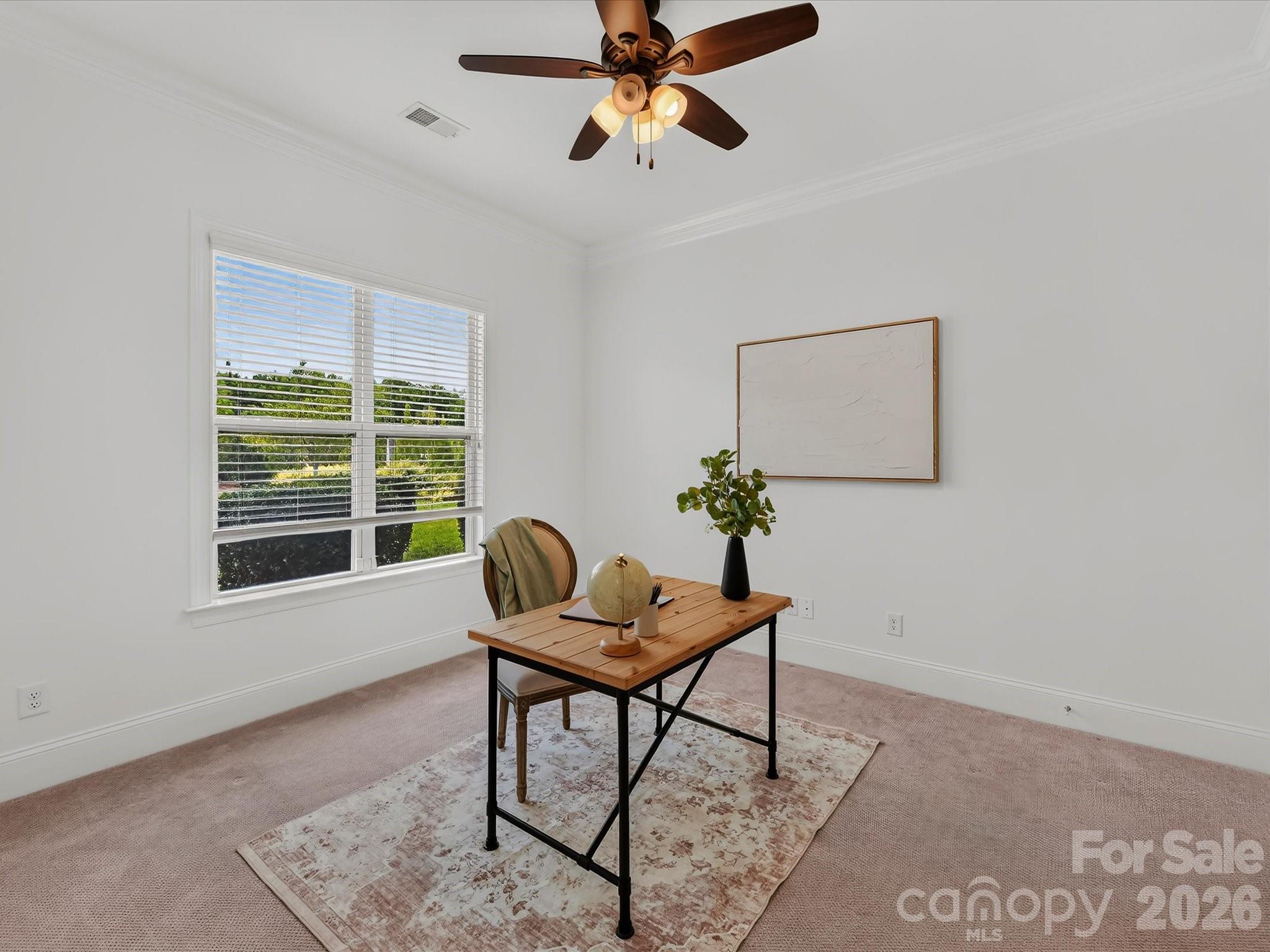 Versatile home office offers abundant natural light, crown molding, French doors, and ample space for a comfortable, private workspace. - 13003 Riley Grace Lane, Cornelius