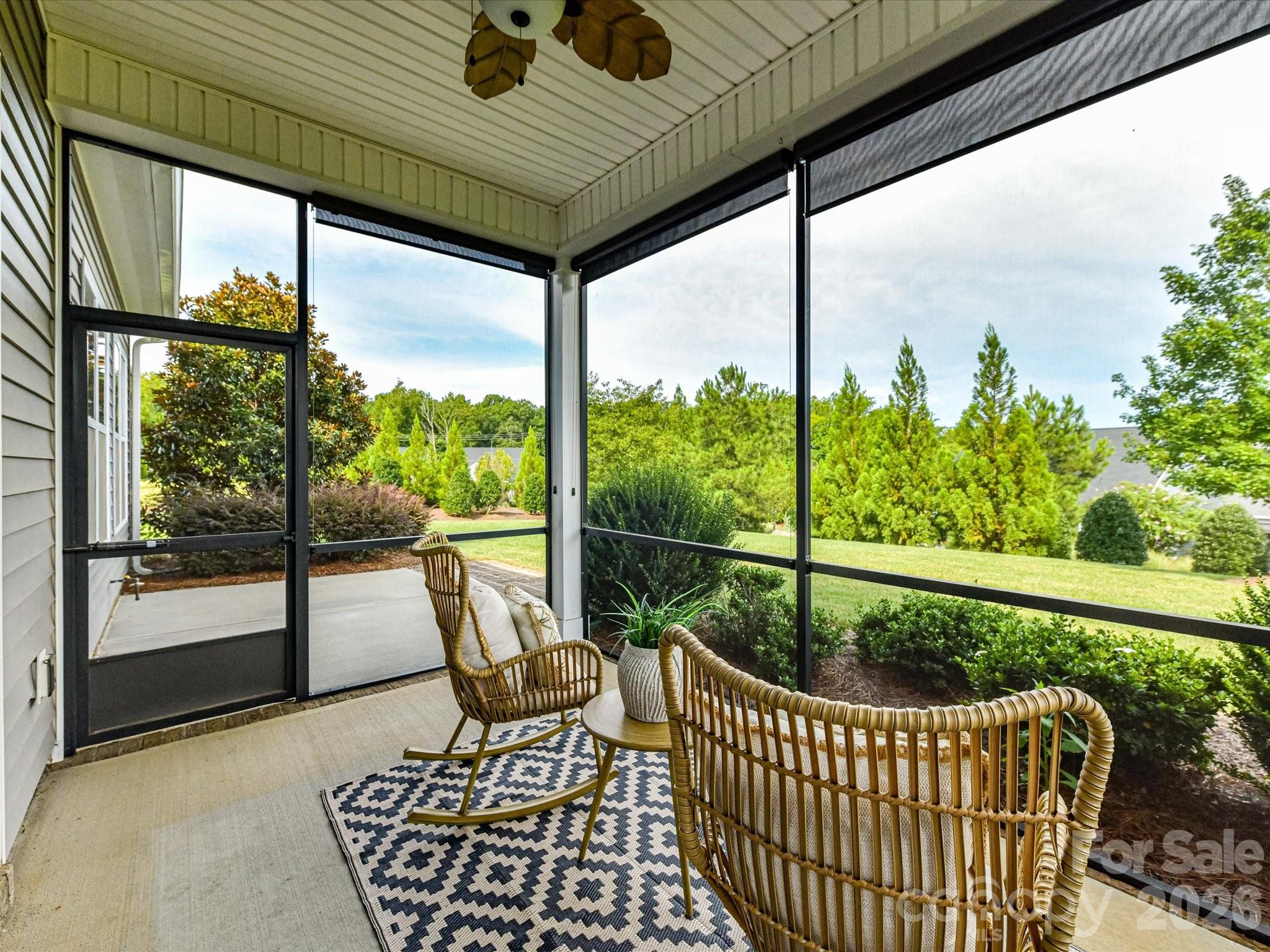 Inviting screened porch offers a peaceful outdoor retreat overlooking the beautifully landscaped backyard. - 13003 Riley Grace Lane, Cornelius