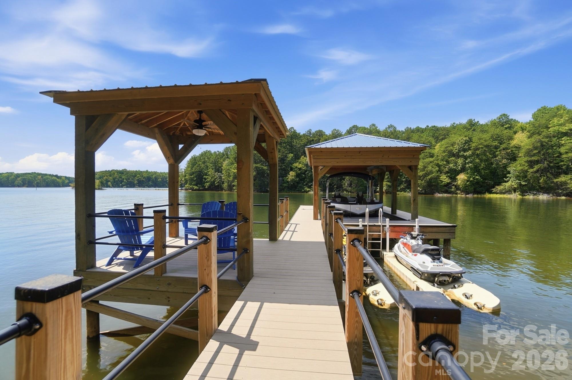Stationary dock with covered boat lift, 2 personal watercraft docks, and covered sitting area - 9265 Belle Pines Court, Sherrills Ford