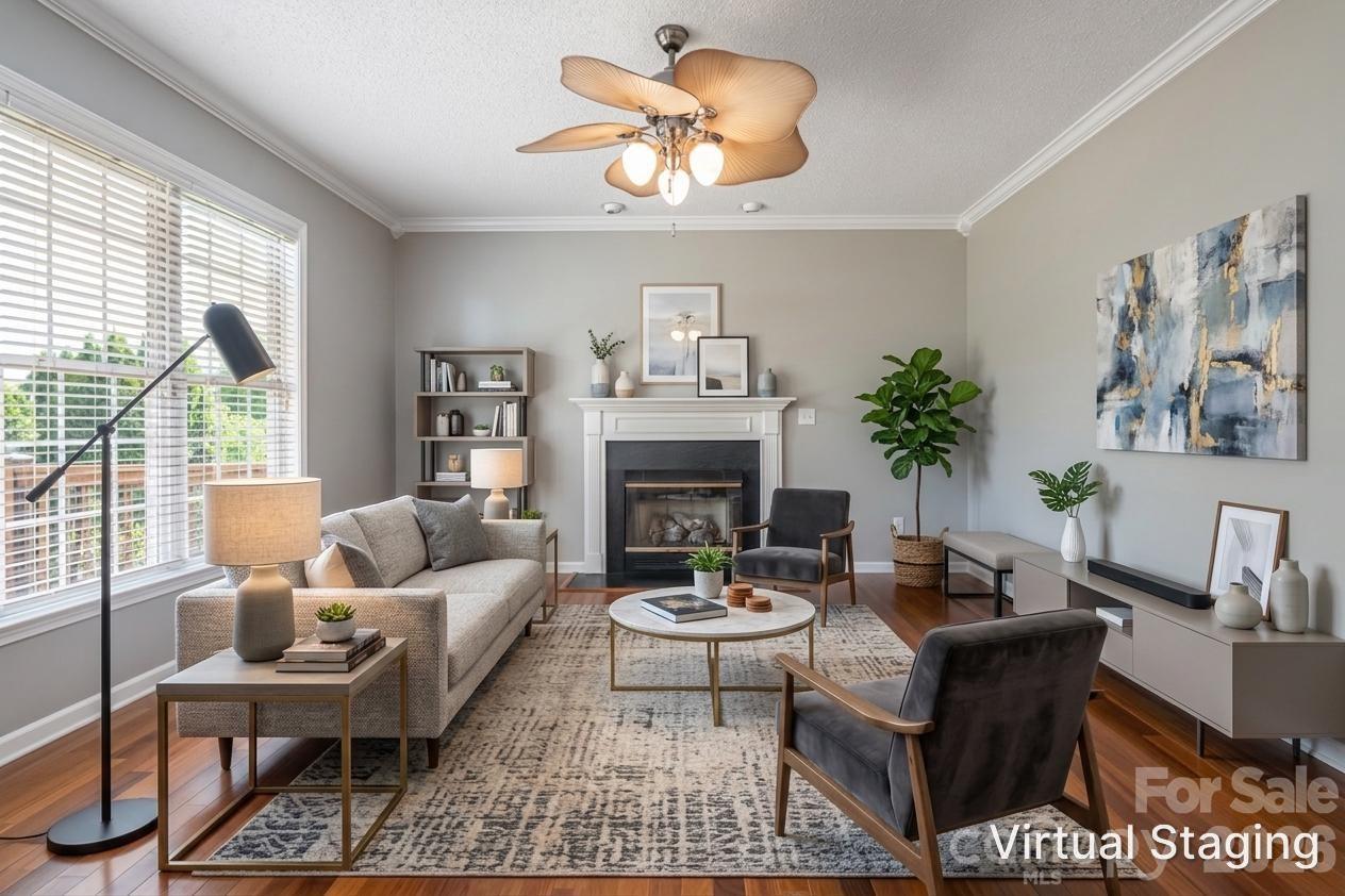 Family room with gas-log fireplace, hardwood floors and windows to the backyard, open to the kitchen and breakfast area. - 48 Brownstone Court, Fletcher