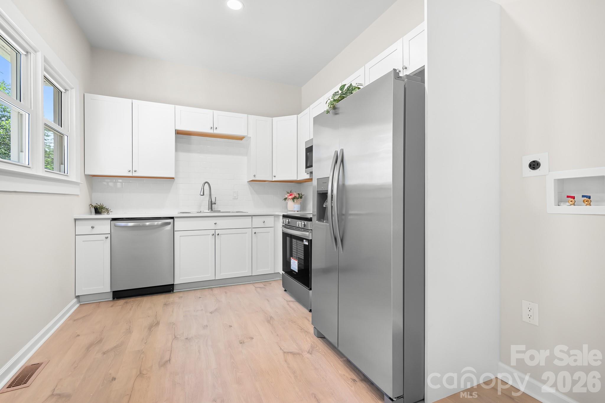 Bright kitchen with brand-new stainless steel appliances. - 104 1st Avenue, China Grove
