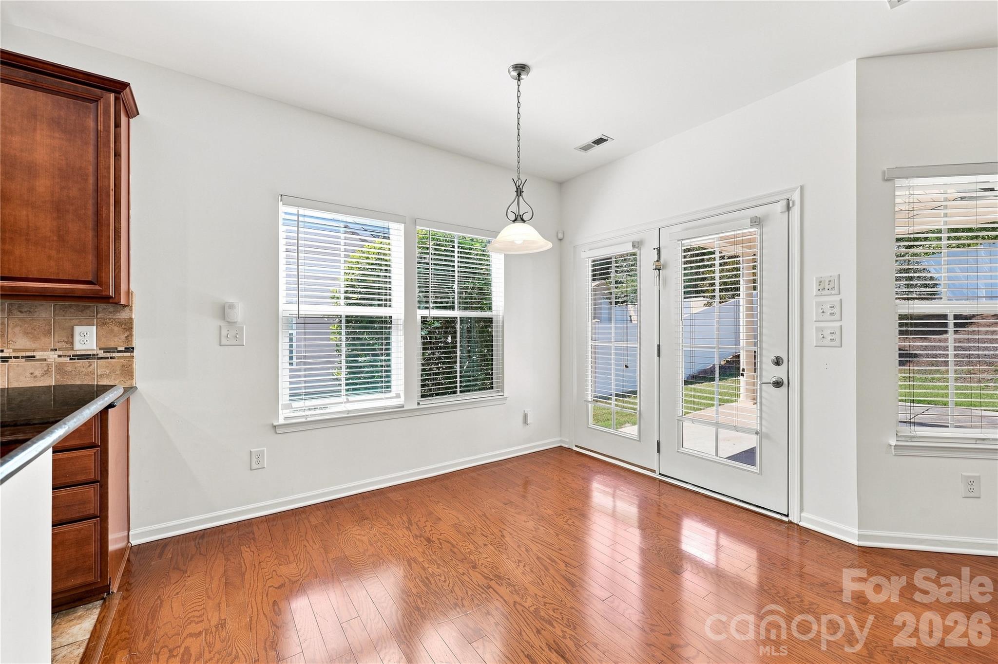 Breakfast nook in kitchen - door leads to back extended, covered patio - 593 Harrison Drive NW, Concord