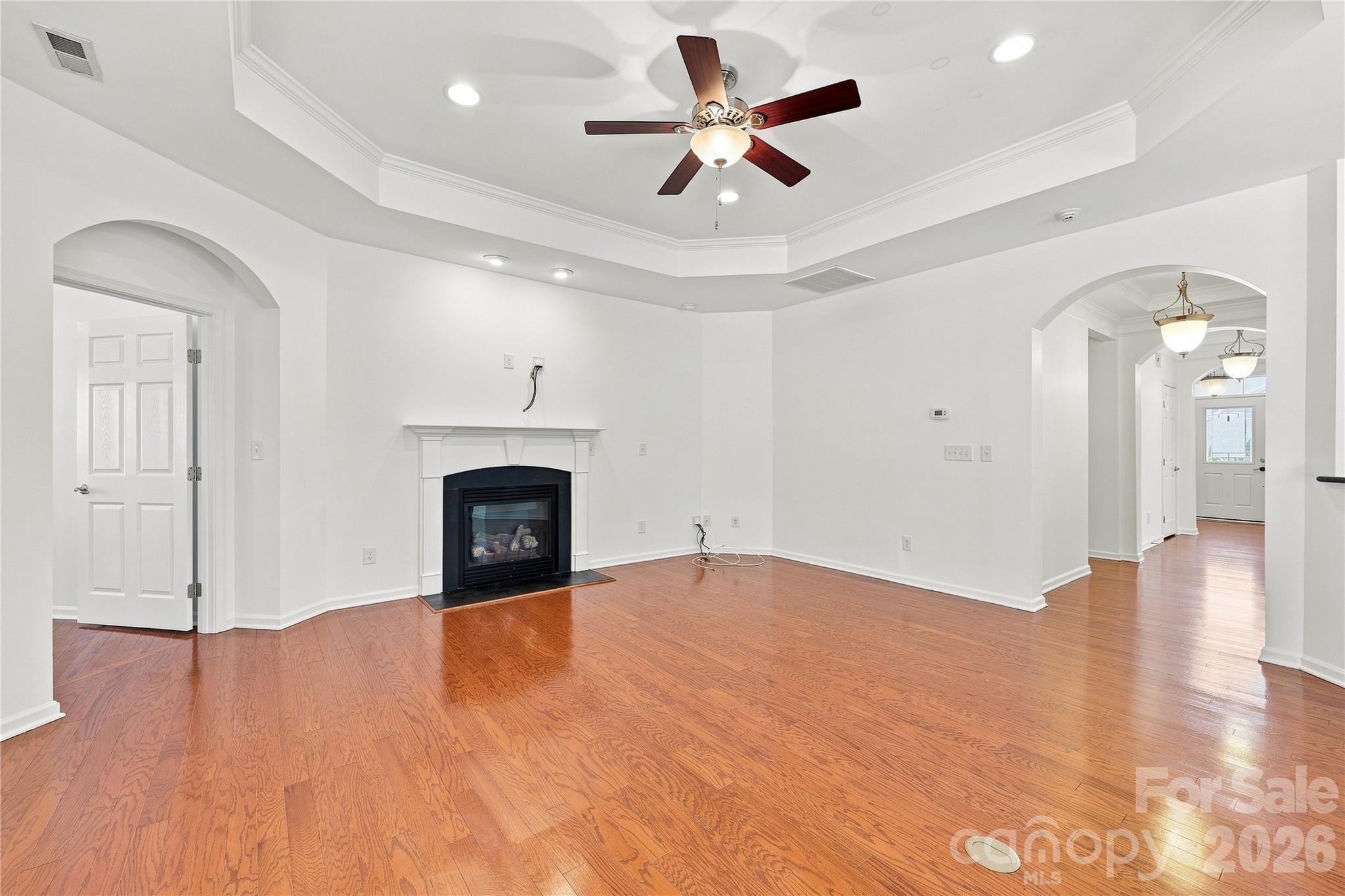 Spacious family room with gas fireplace, trey ceiling with fan - 593 Harrison Drive NW, Concord