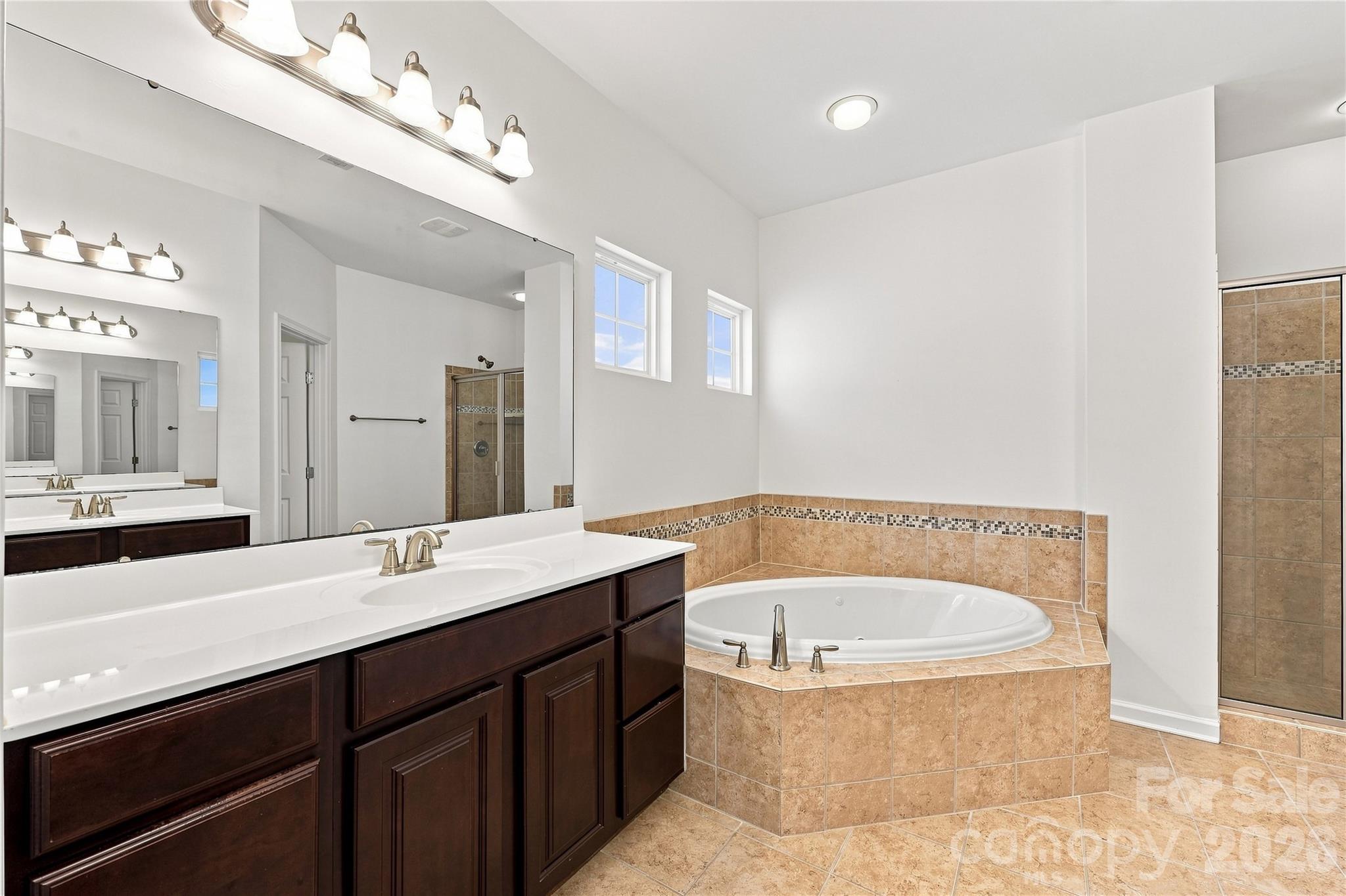 Primary bathroom with double sinks, jetted tub and separate shower - 593 Harrison Drive NW, Concord