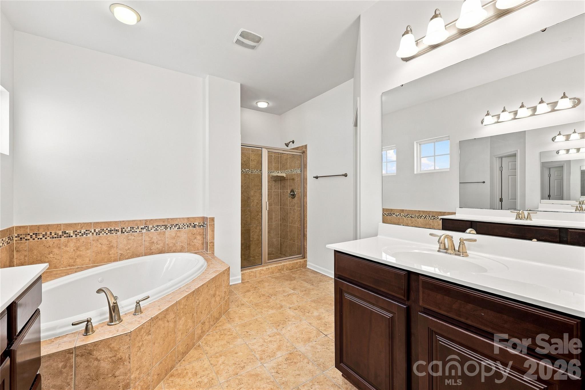 Primary bathroom with double sinks, jetted tub and separate shower - 593 Harrison Drive NW, Concord