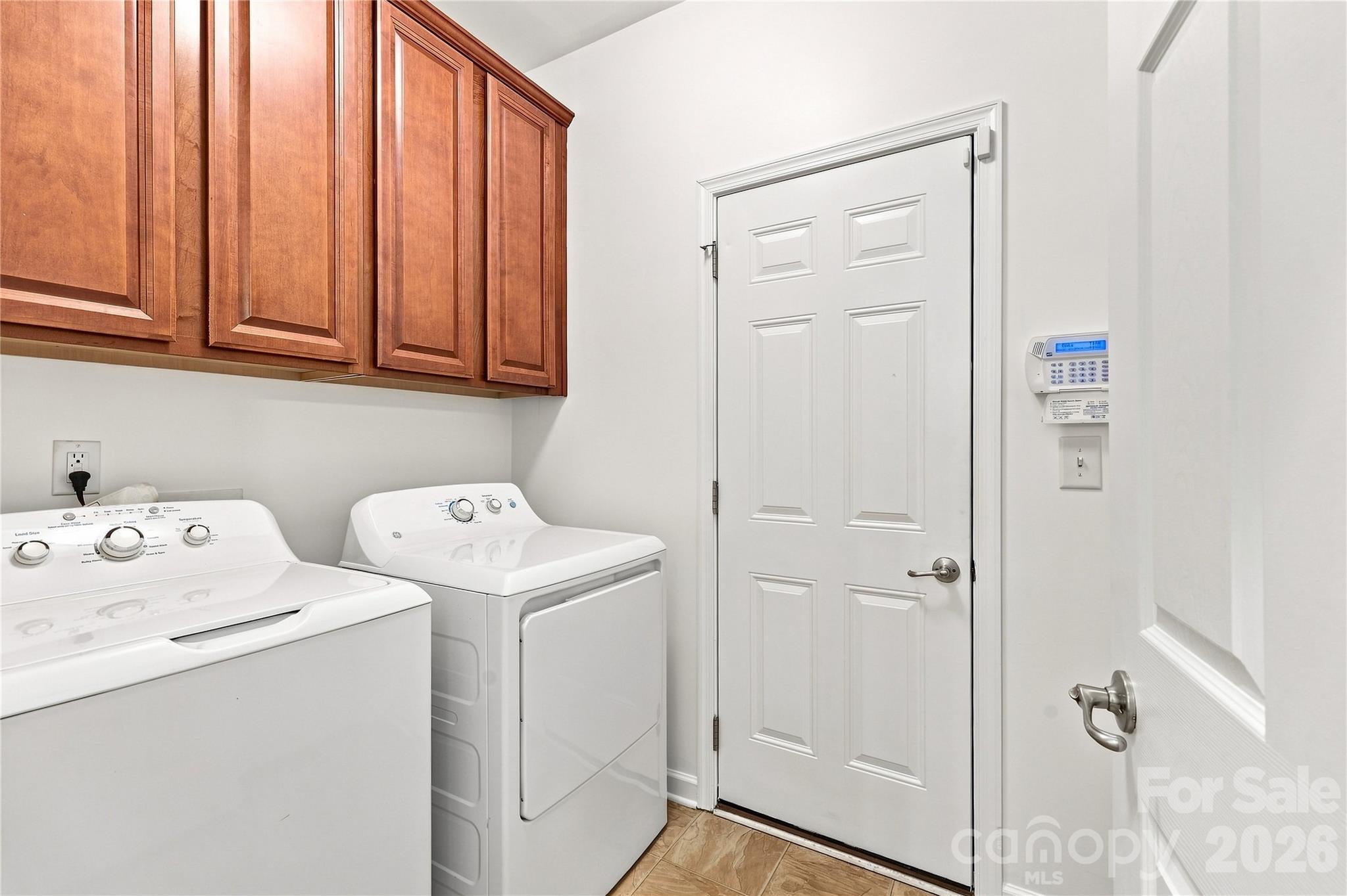 Laundry room with 32 in cabinets for storage leads to garage - 593 Harrison Drive NW, Concord