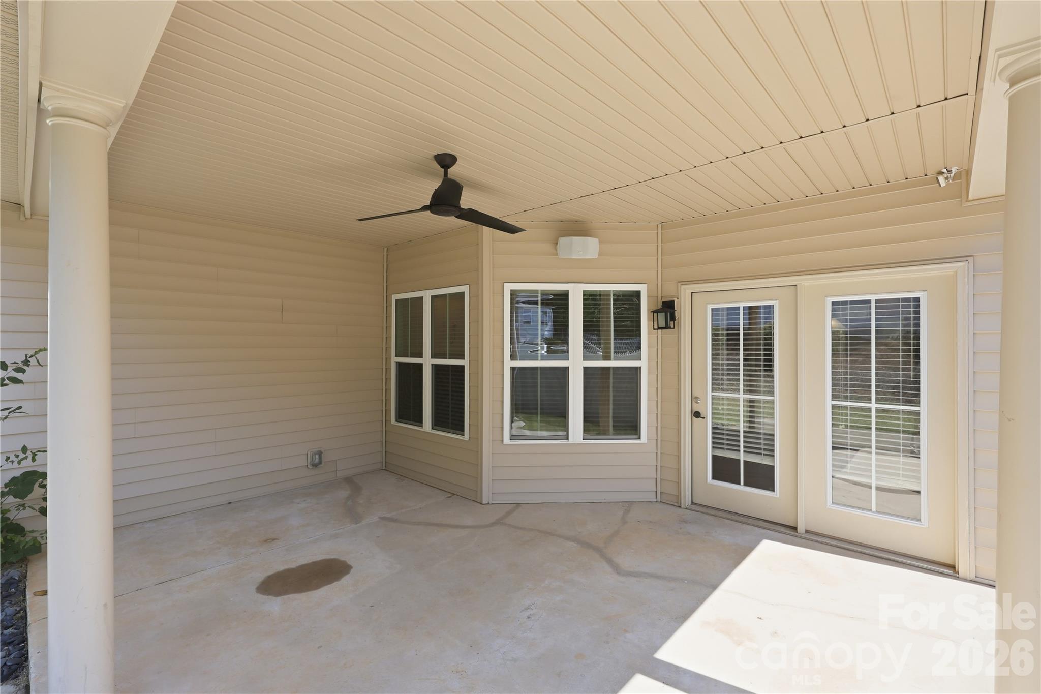 Extended covered patio with ceiling fan accessed from kitchen - 593 Harrison Drive NW, Concord