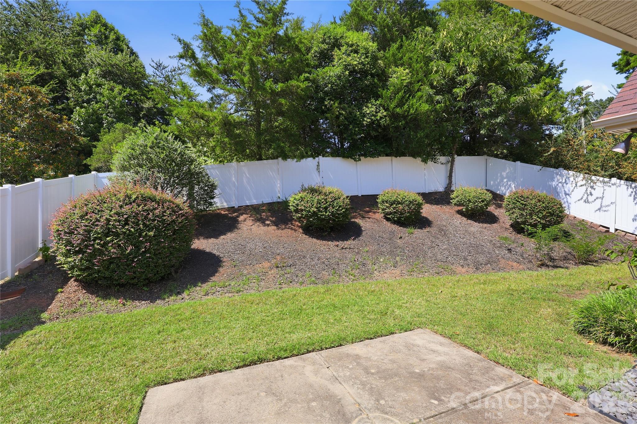 Landscaped rear yard with privacy white vinyl fencing - 593 Harrison Drive NW, Concord