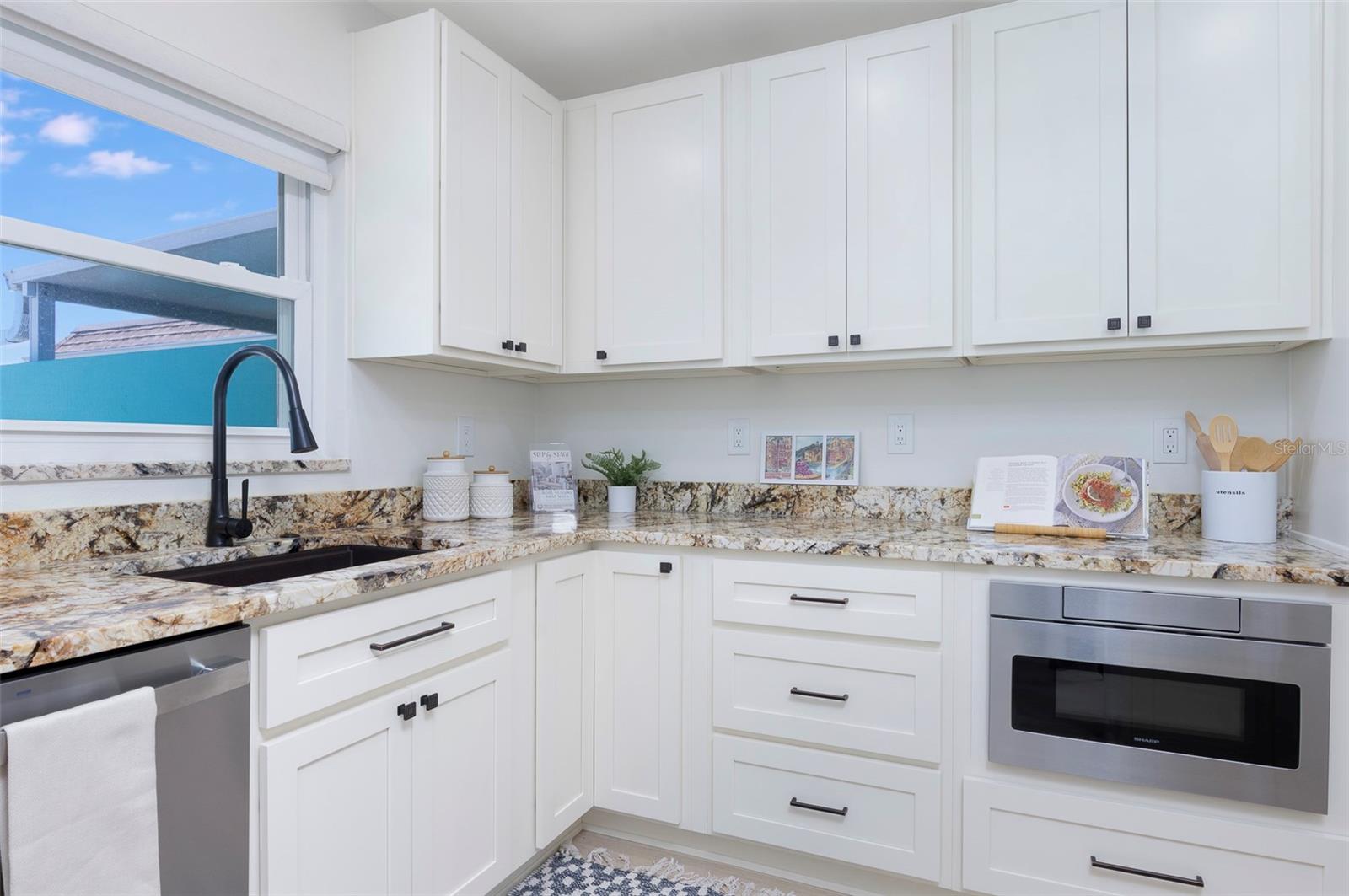 Another view to show the functional kitchen. Window look out to the paved larage courtyard. - 382 BOCA CIEGA POINT BLVD S, ST PETERSBURG