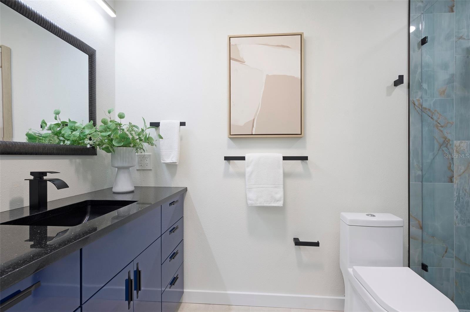 The Primary bathroom is functional and features designer touches. A tube skylight brings in natural light. - 382 BOCA CIEGA POINT BLVD S, ST PETERSBURG