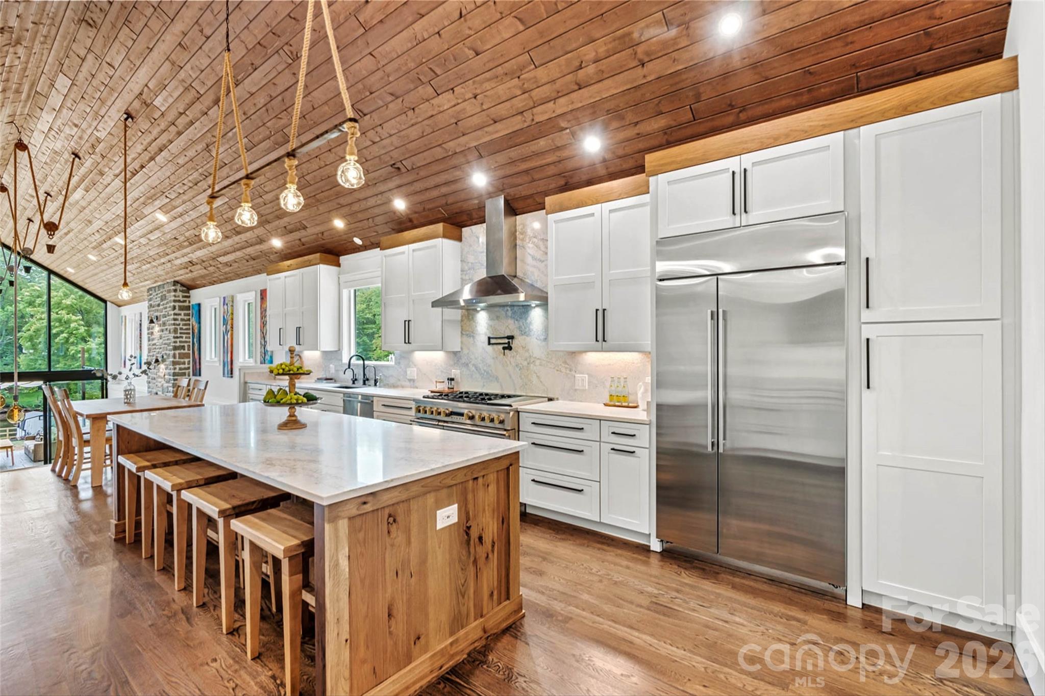 T&G wood vaulted ceiling through chef's kitchen and into family room! - 7834 Green Cove Court, Denver