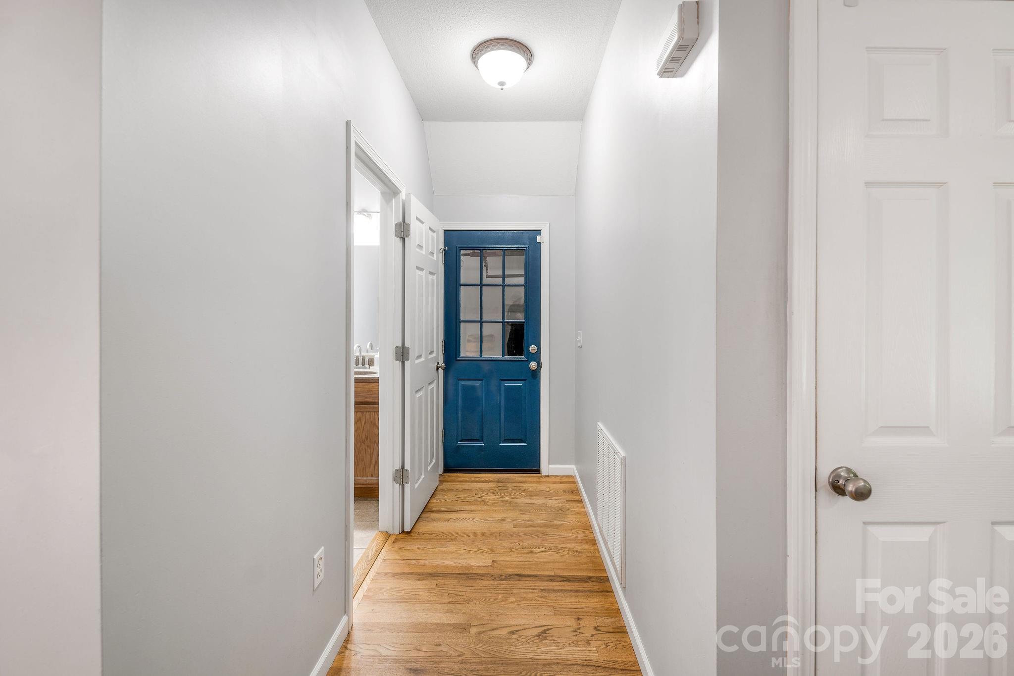 Hallway to garage & 1/2 bath on Main level - 19 Oakcrest Place, Asheville