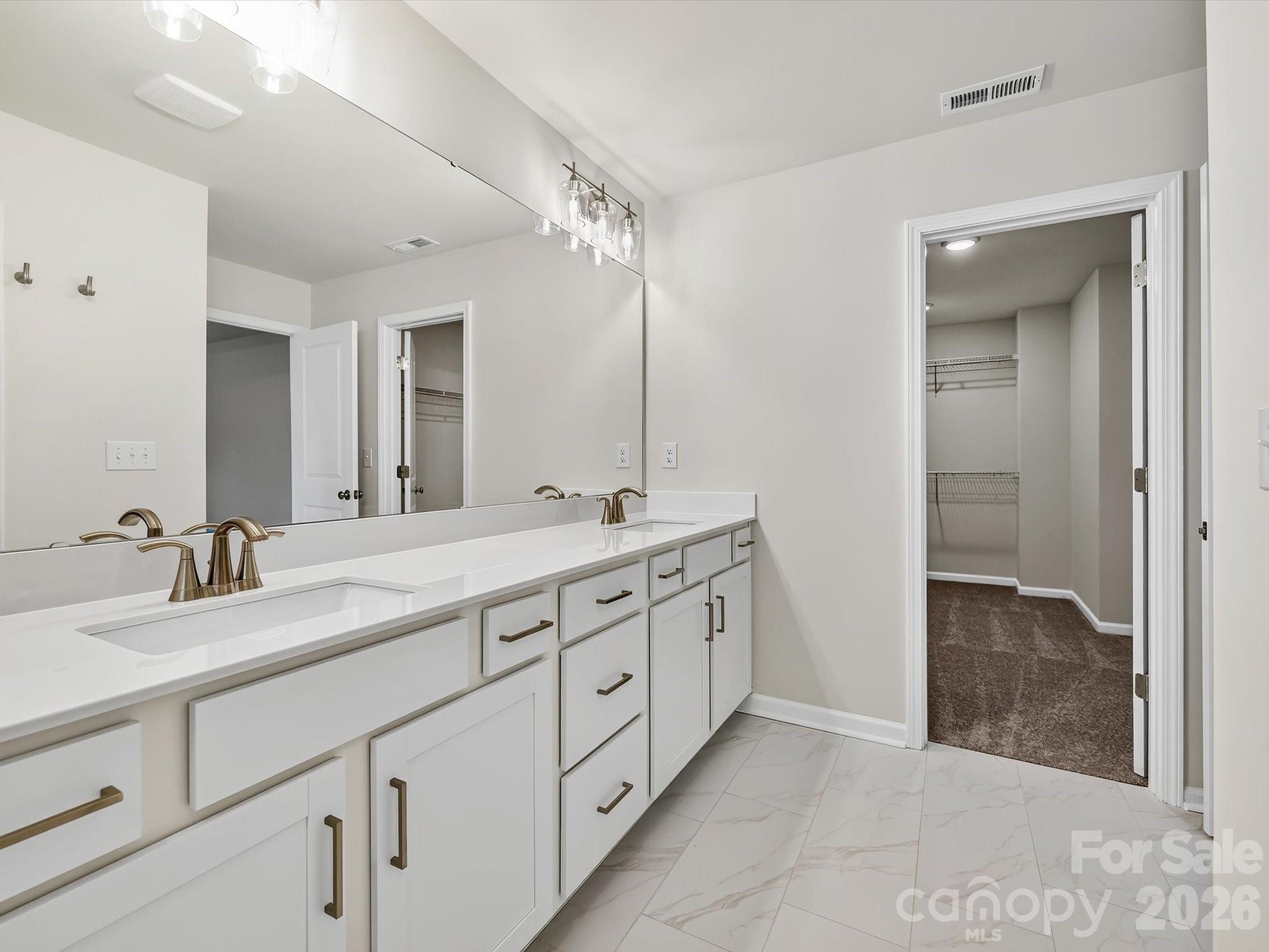 Laundry room with folding table - 280 Alluvium Lane, Waxhaw