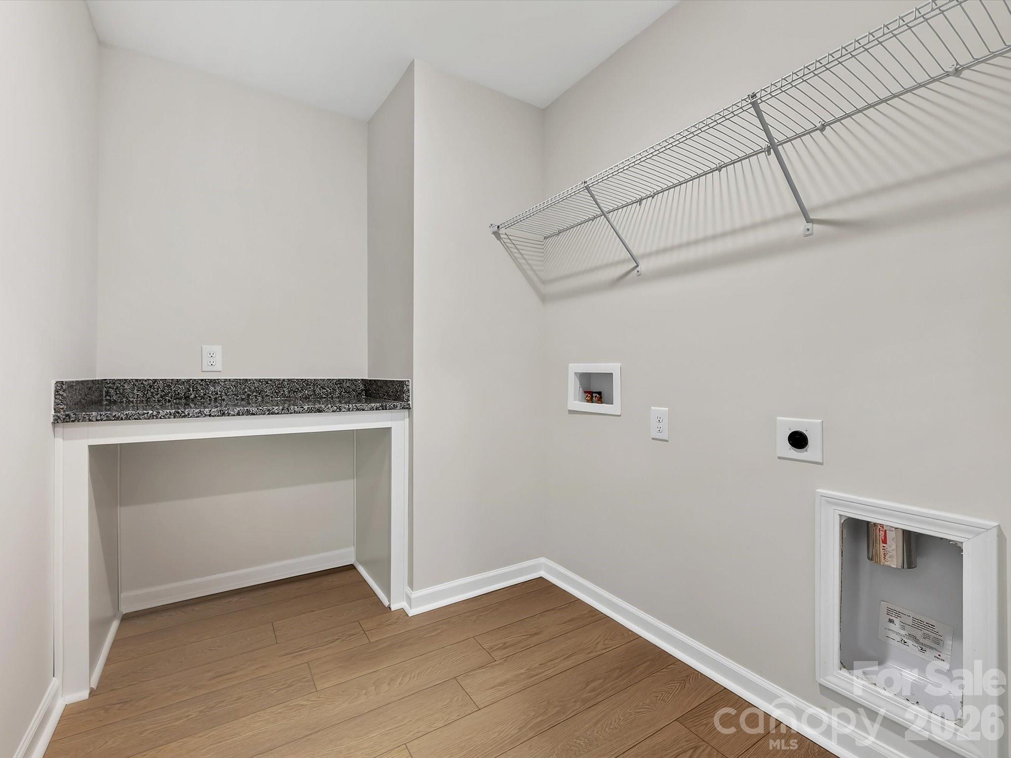 Laundry room with folding table - 280 Alluvium Lane, Waxhaw