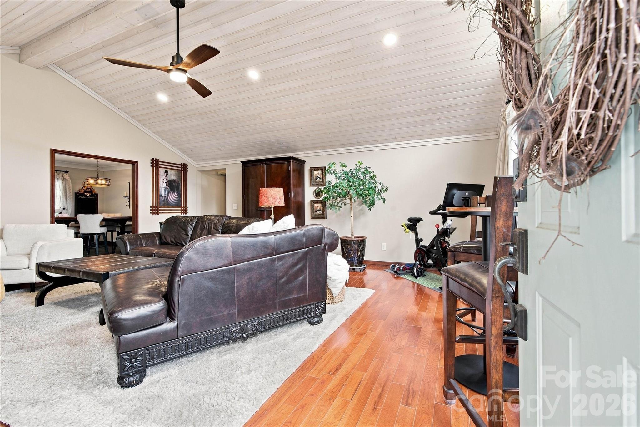 Family Room measures 21.3x21.11 and features a beautiful tongue and groove whitewashed cathedral ceiling and gleaming wood floors. - 3867 Angie Drive, Denver