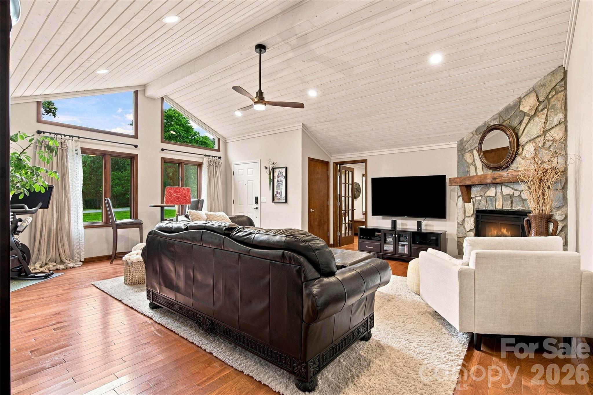 Bright, natural light floods this spacious family room through a large front wall of windows, creating an open and inviting atmosphere. - 3867 Angie Drive, Denver