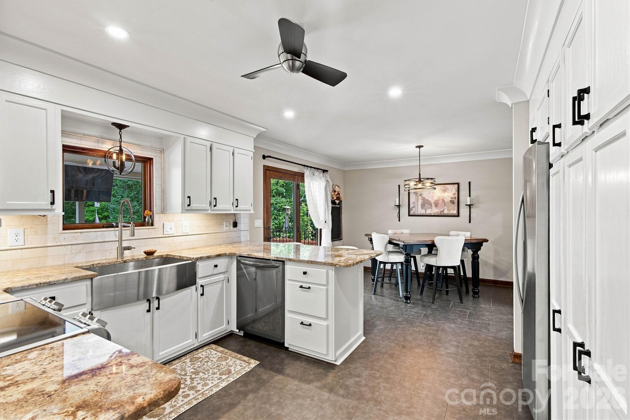Kitchen has no shortage of cabinetry and built in pantry space. Nice dining area conveniently located next to Kitchen. - 3867 Angie Drive, Denver